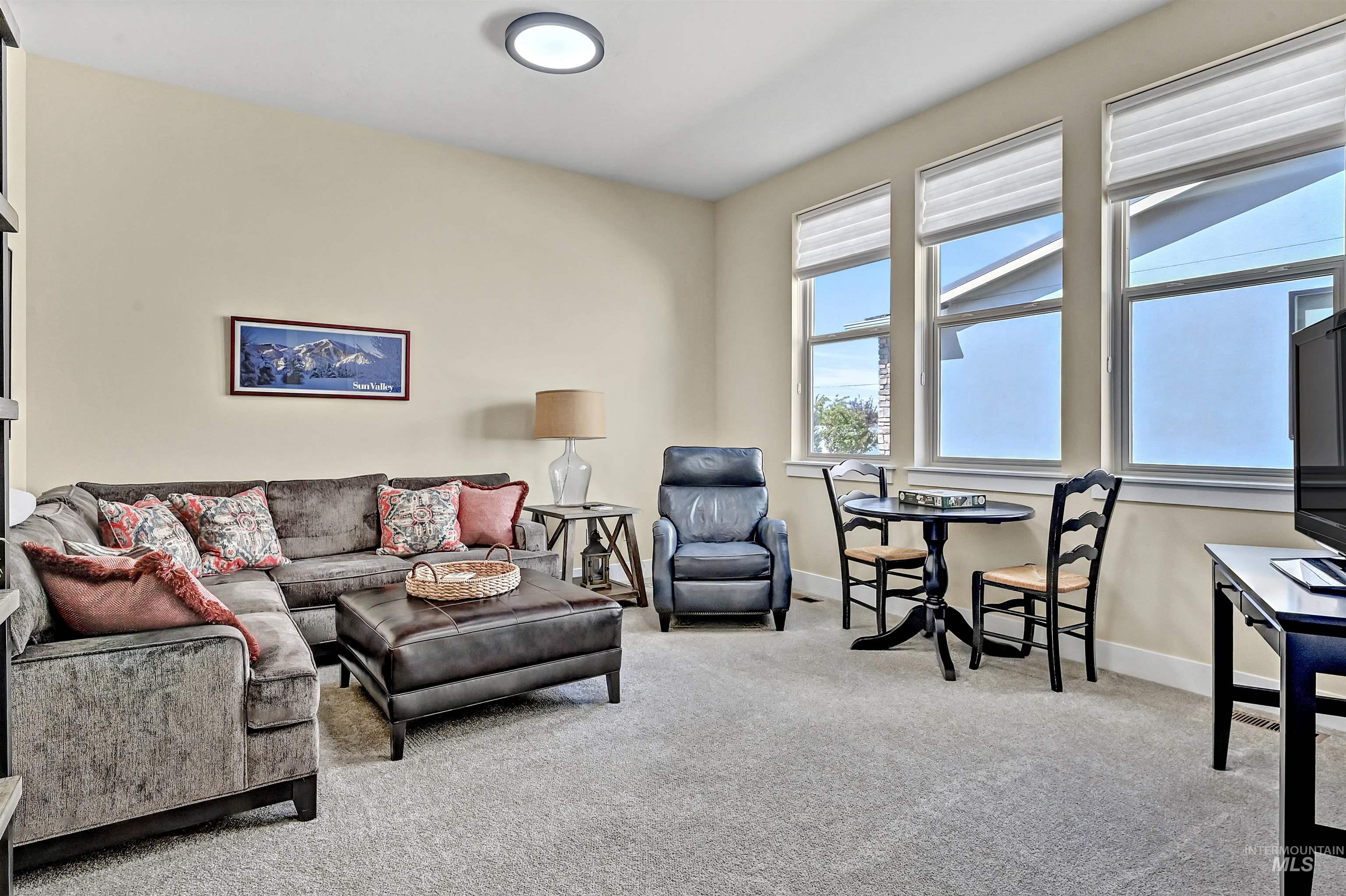 Carpeted living area with baseboards