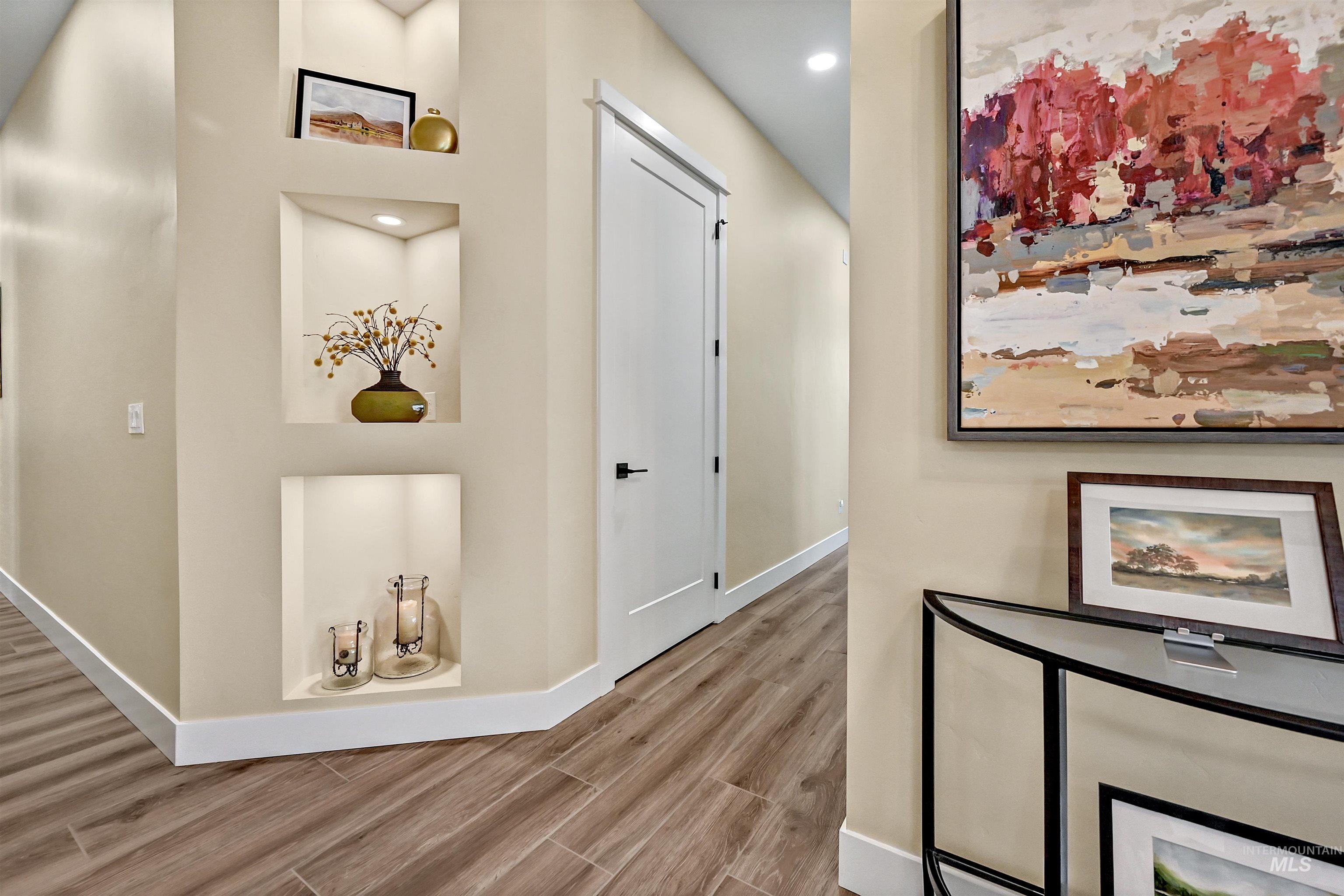 Hallway featuring wood finished floors and recessed lighting