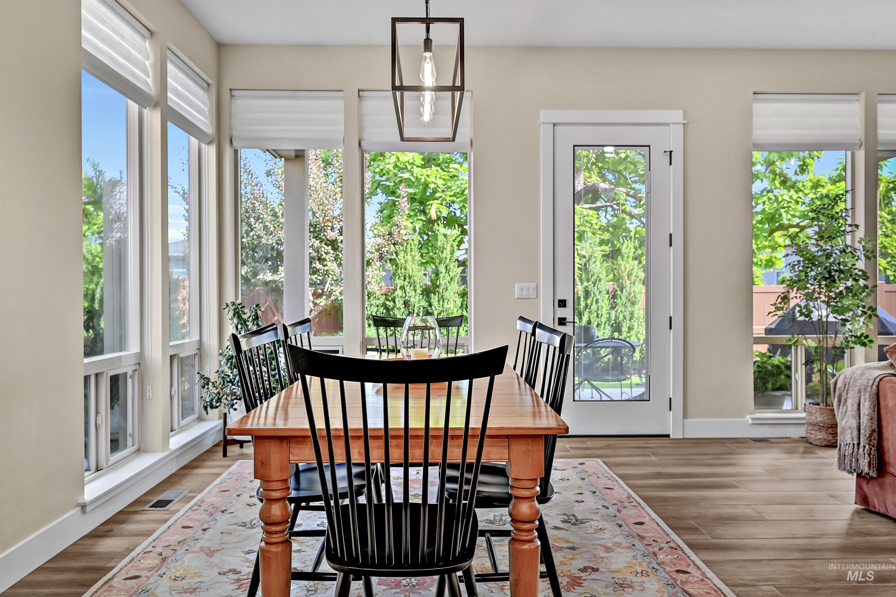 Dining space featuring healthy amount of natural light and wood finished floors