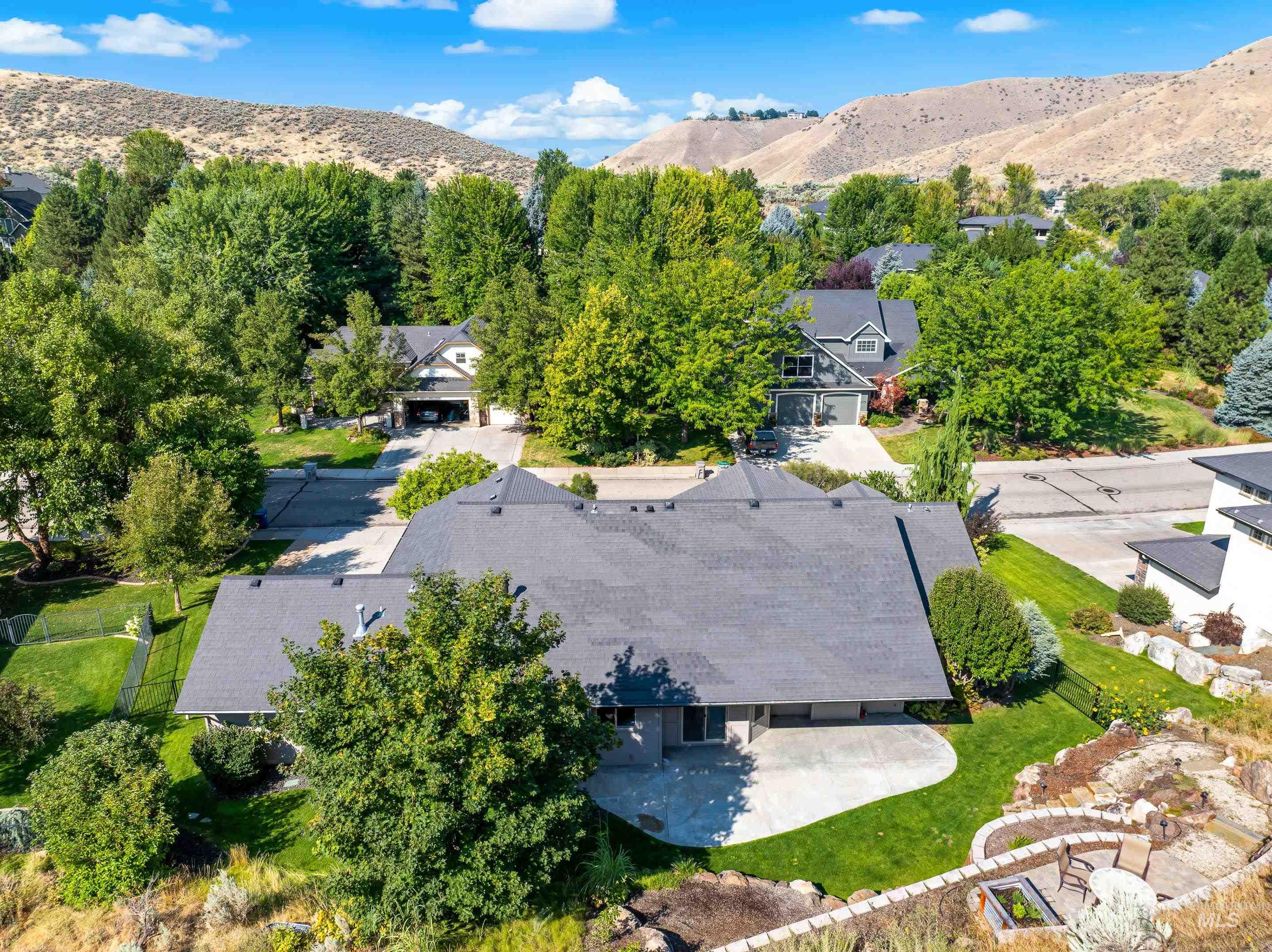 Aerial view of residential area featuring a mountainous background