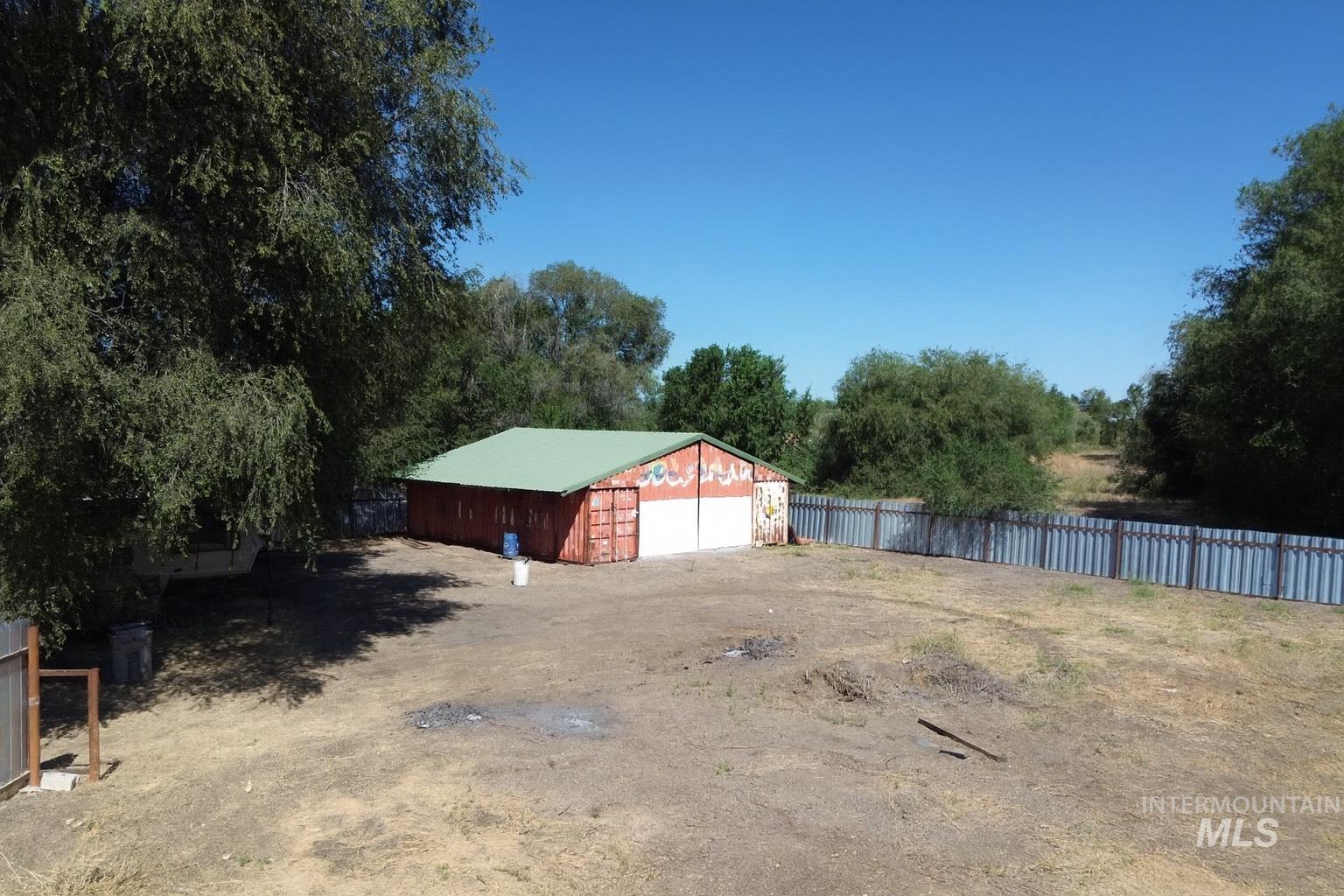 View of yard featuring an outbuilding, a detached garage, and driveway