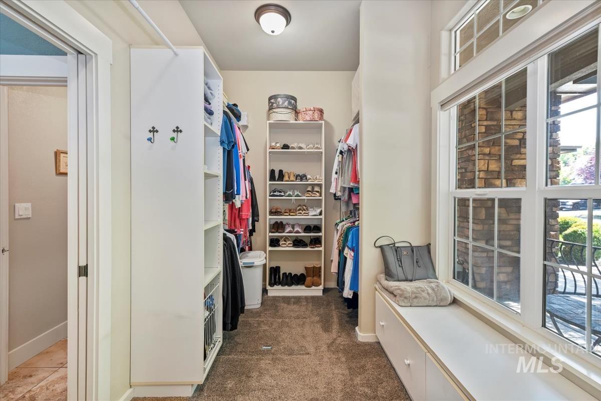 Walk in closet featuring dark colored carpet