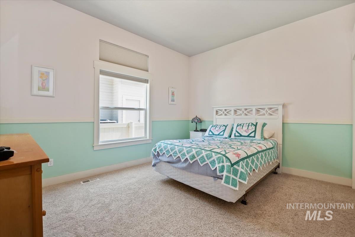 Carpeted bedroom featuring baseboards