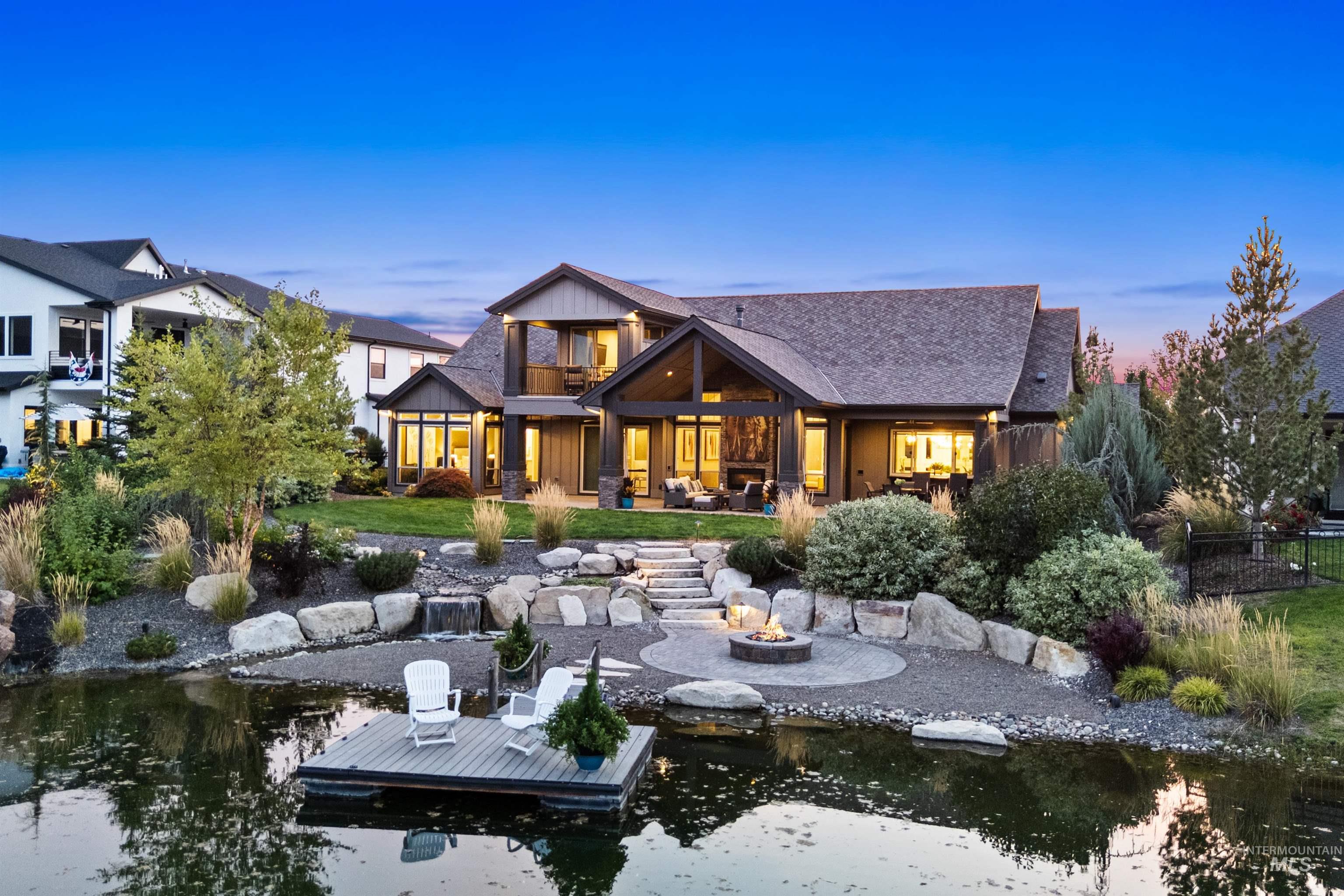 Back of property at dusk with a patio, an outdoor fire pit, and a balcony