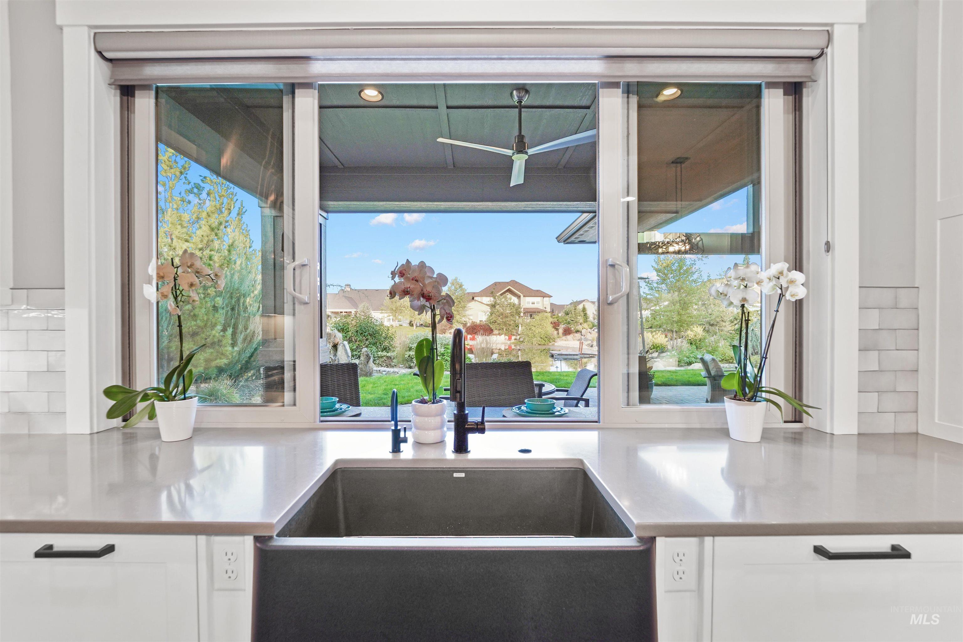 Kitchen view of tasteful backsplash and white cabinets