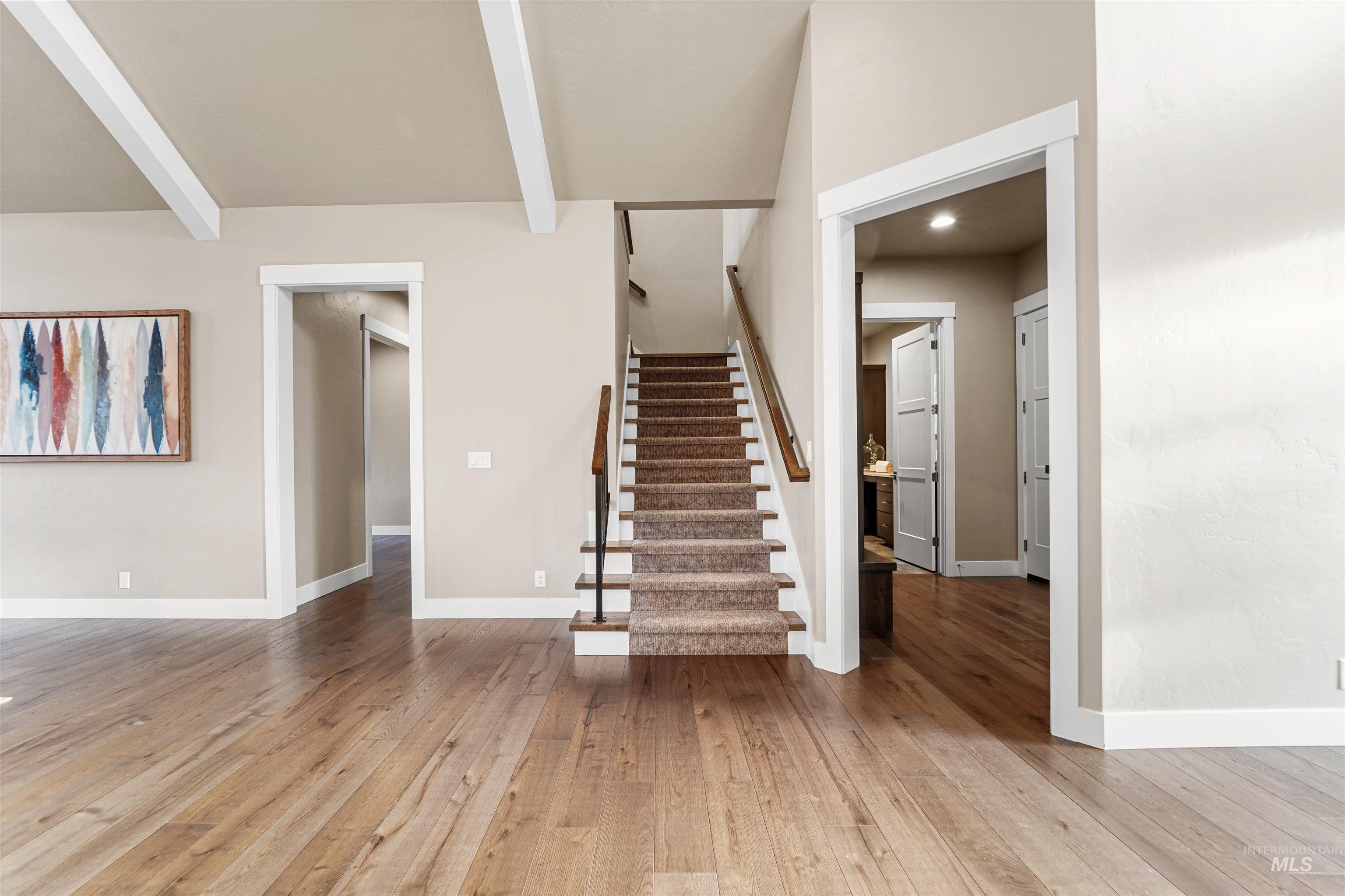 Stairway featuring hardwood / wood-style flooring