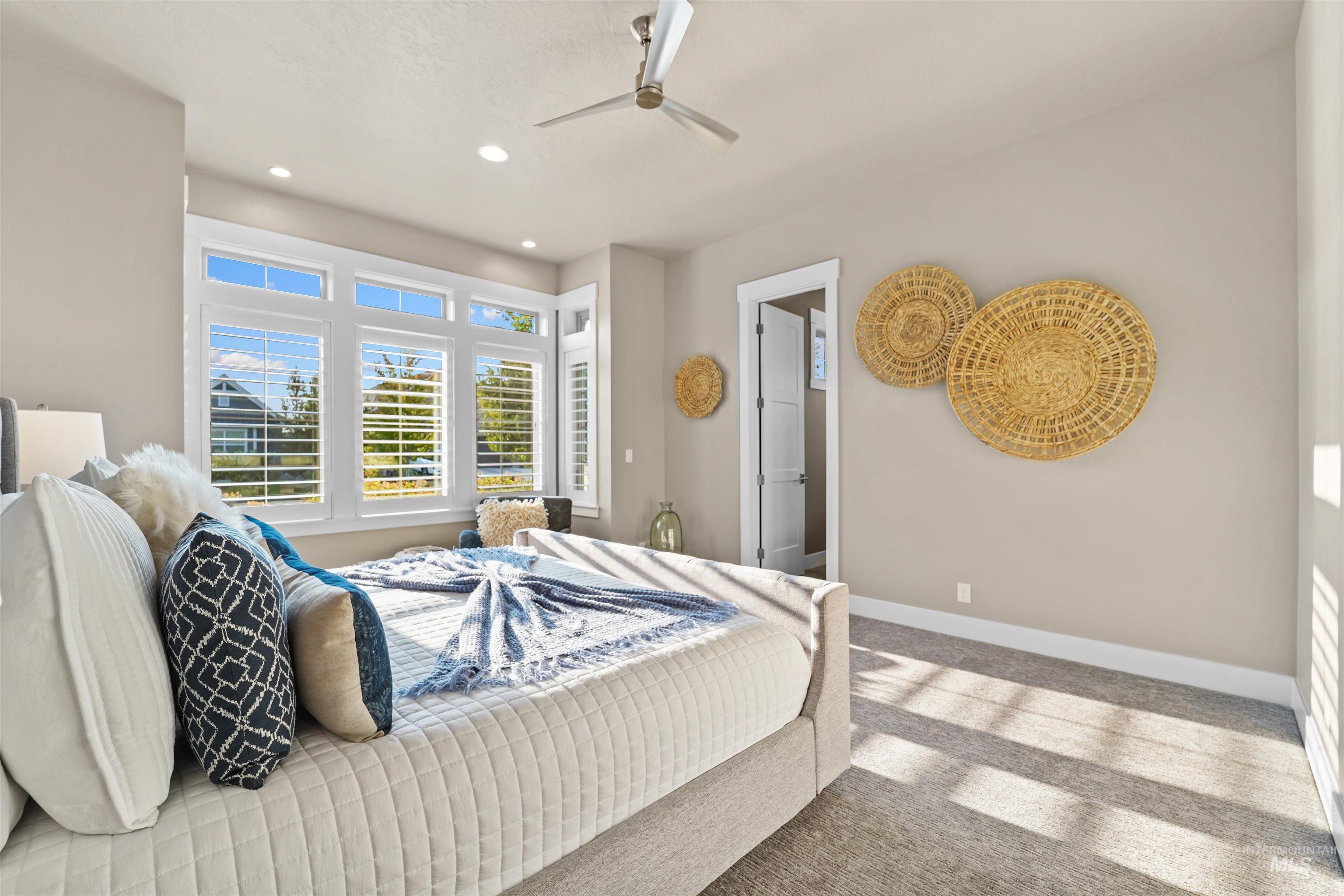 Bedroom with light carpet, recessed lighting, and a ceiling fan