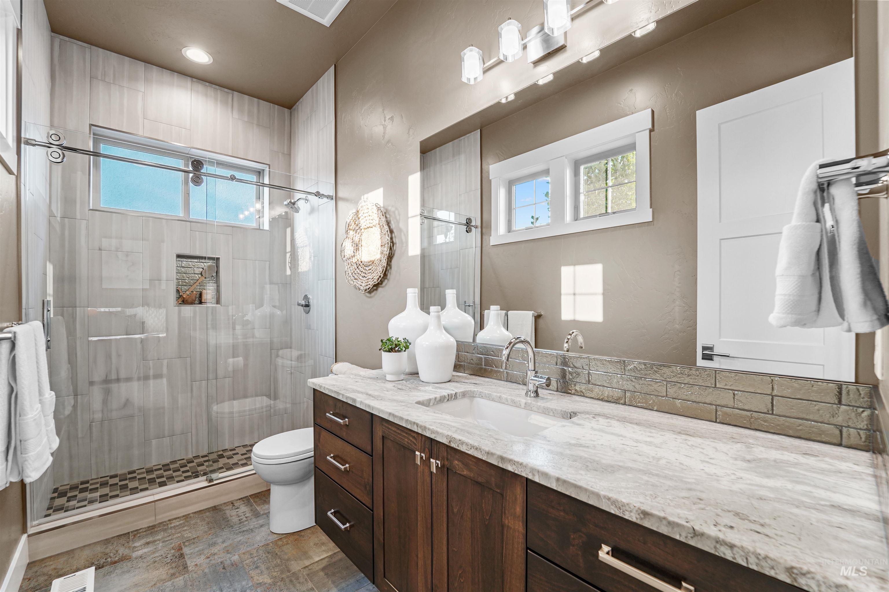 Full bath with vanity and a stall shower