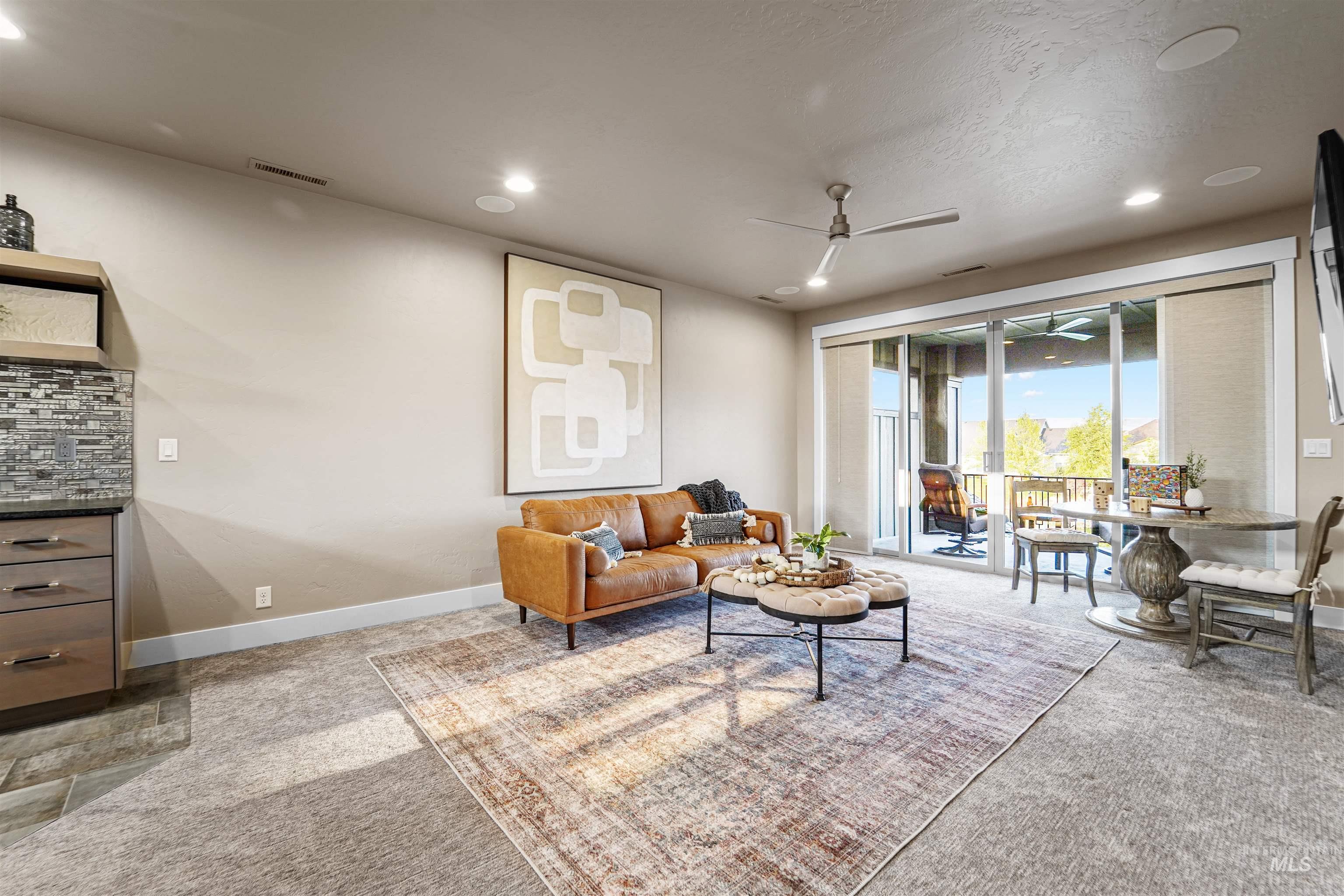 Living area featuring ceiling fan, recessed lighting, and light colored carpet