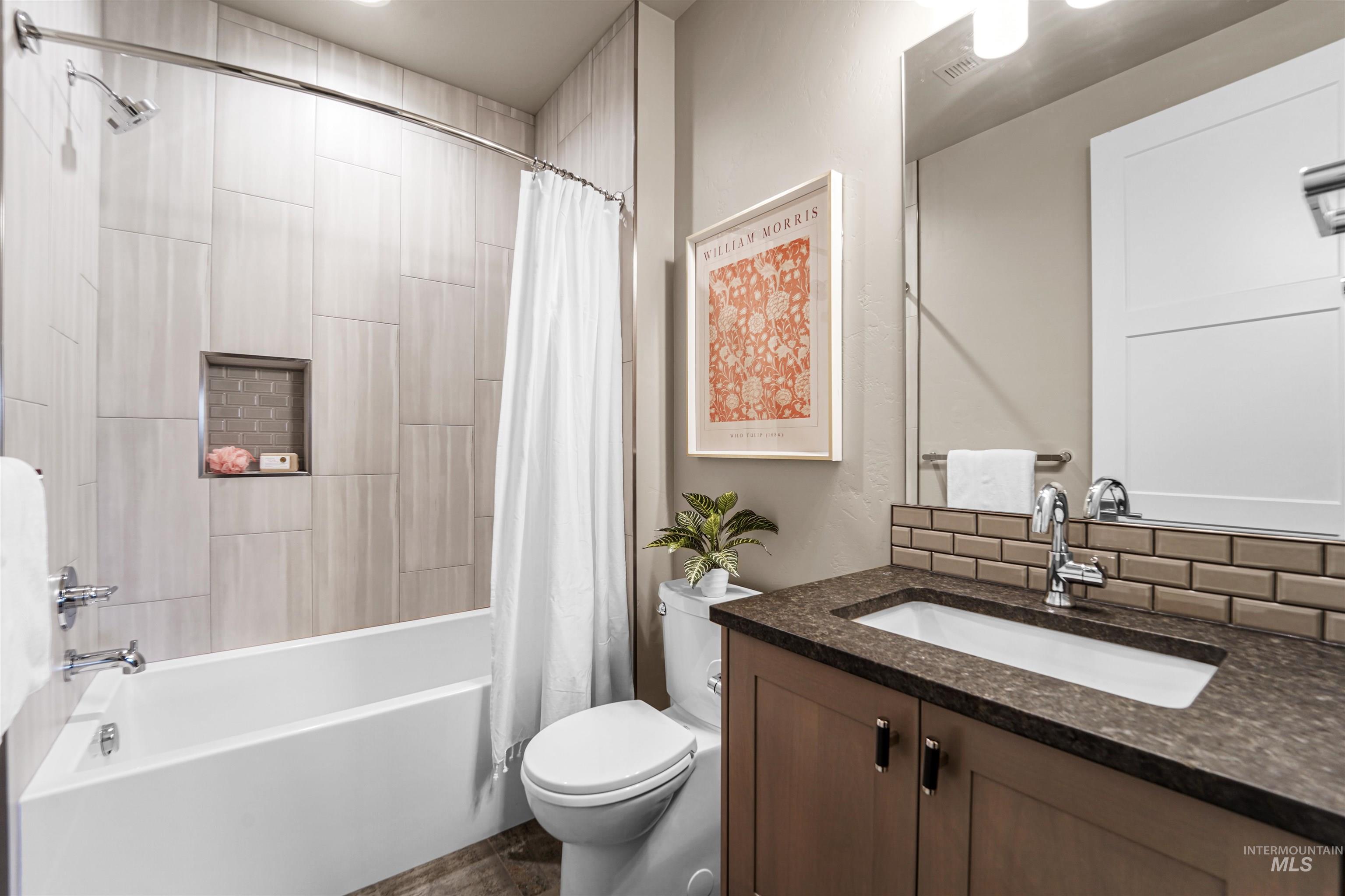 Full bath featuring shower / bath combo and vanity