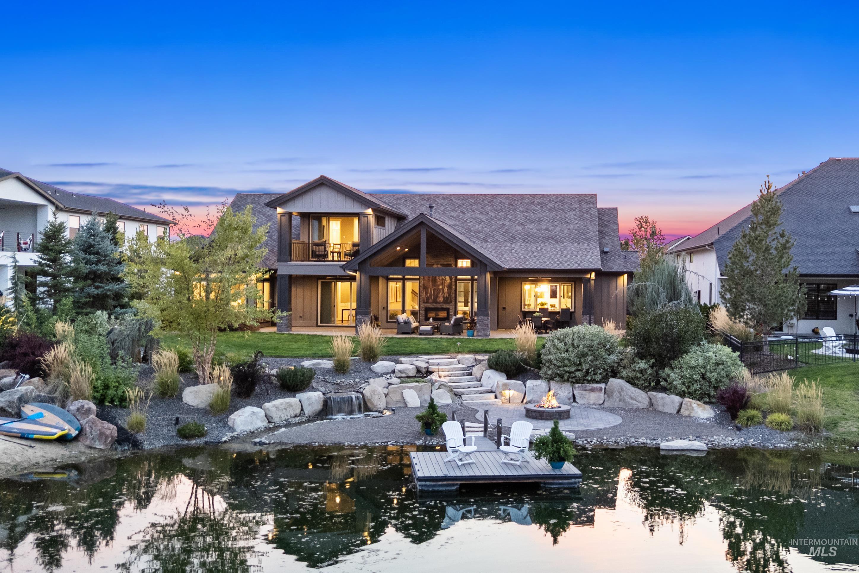 Back of property at dusk with a patio, an outdoor living space with a fire pit, and a balcony