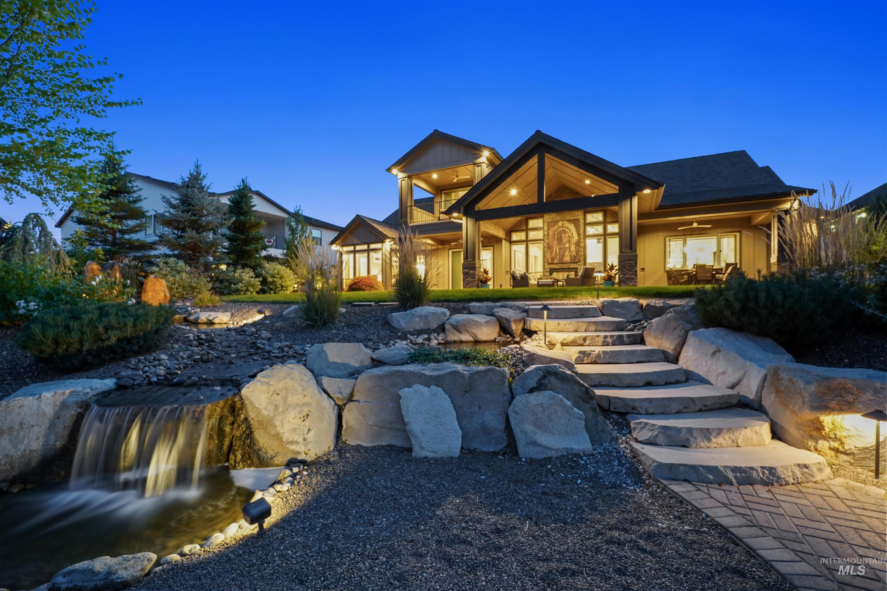 Rear view of property featuring a patio area and a garden pond