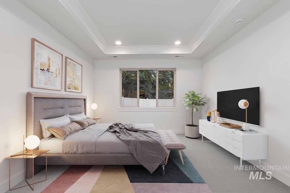 Carpeted bedroom with recessed lighting, a raised ceiling, and ornamental molding