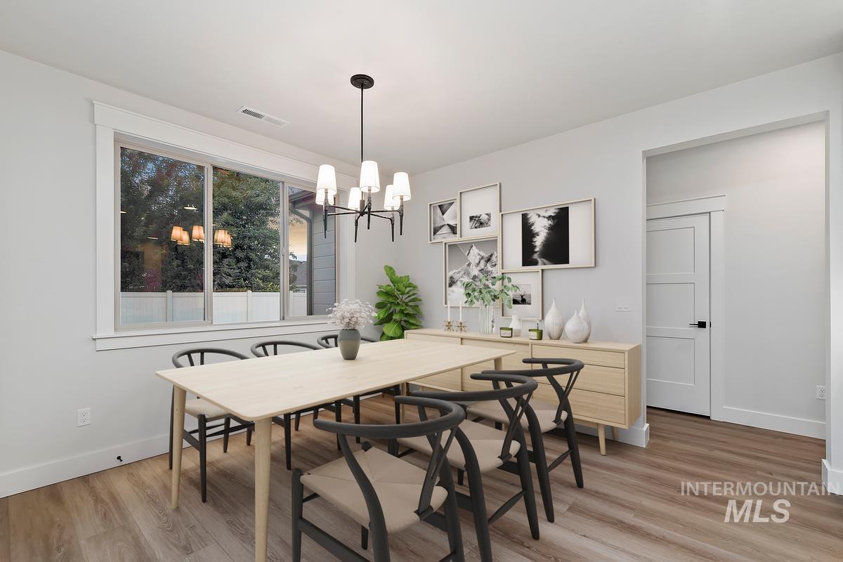 Dining area featuring a chandelier and light wood-style floors