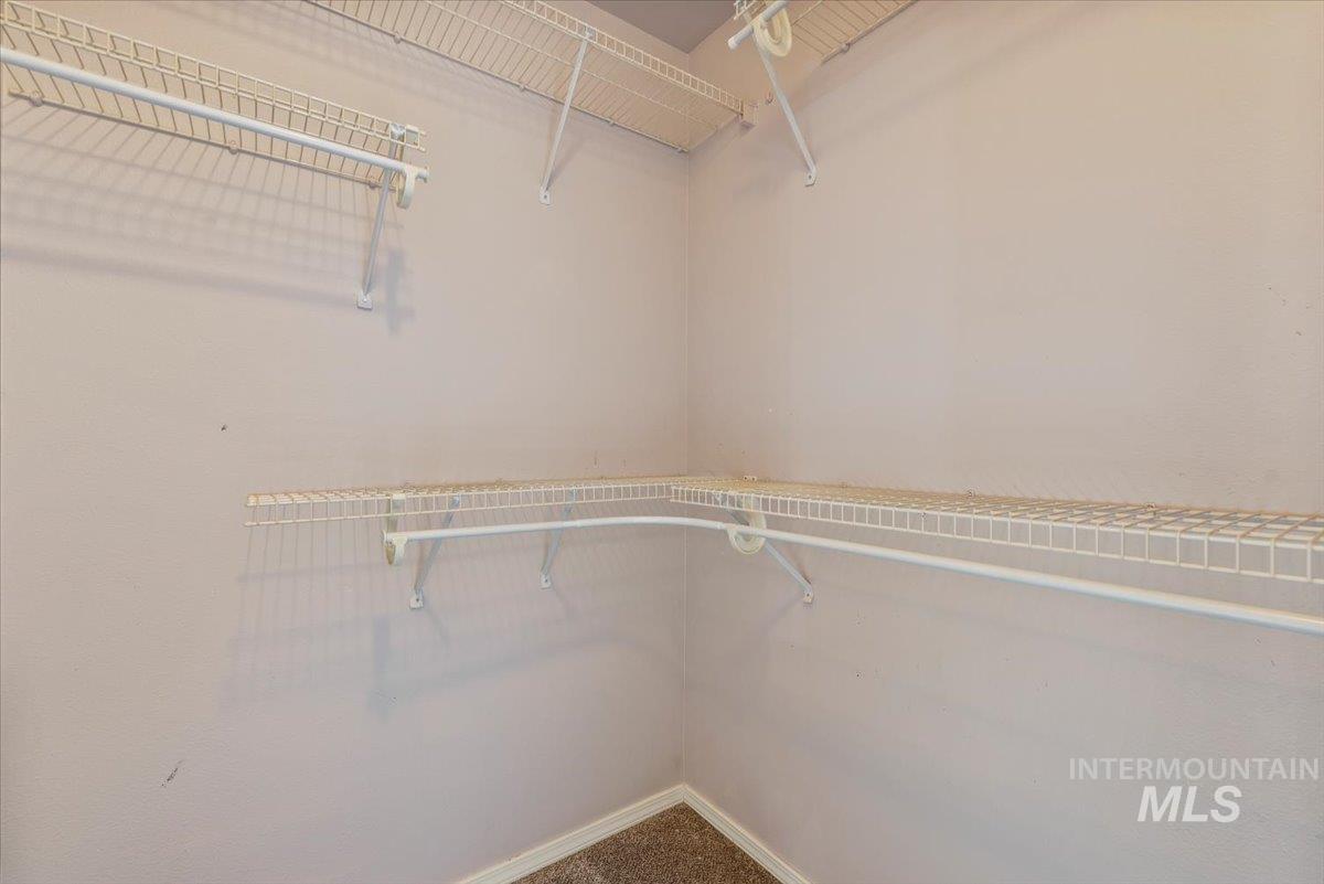 Spacious closet with carpet flooring