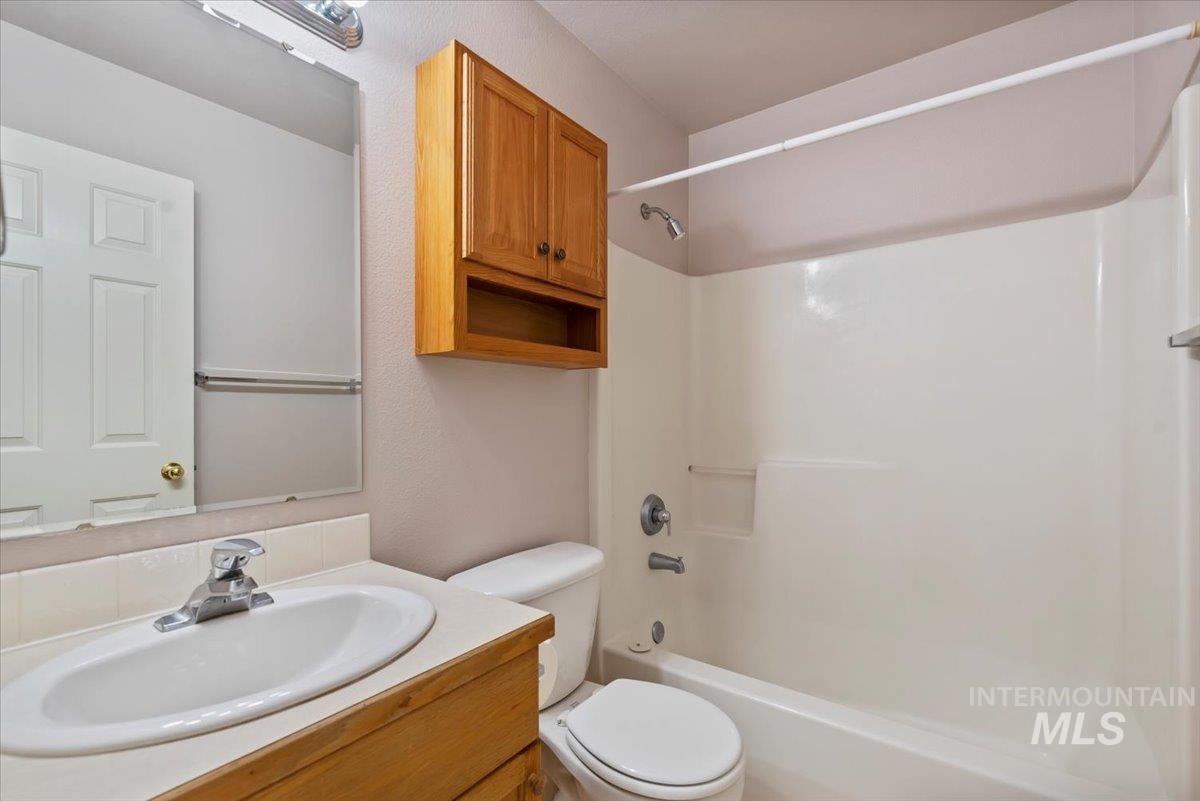 Bathroom featuring shower / tub combination and vanity