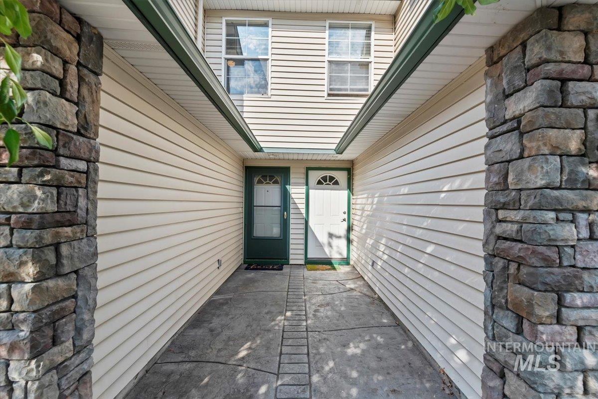 View of exterior entry with stone siding