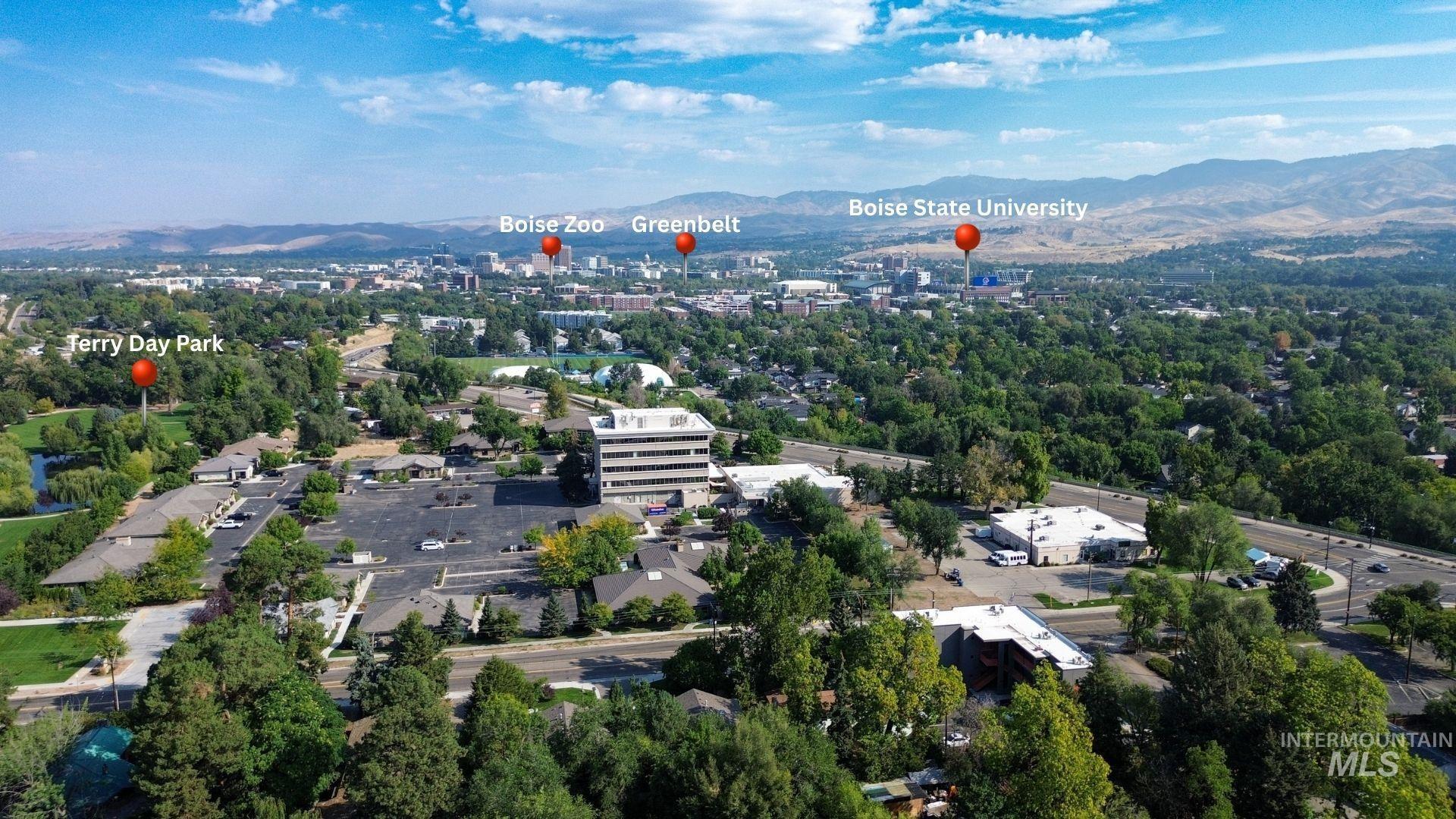 Aerial view of property and surrounding area featuring mountains
