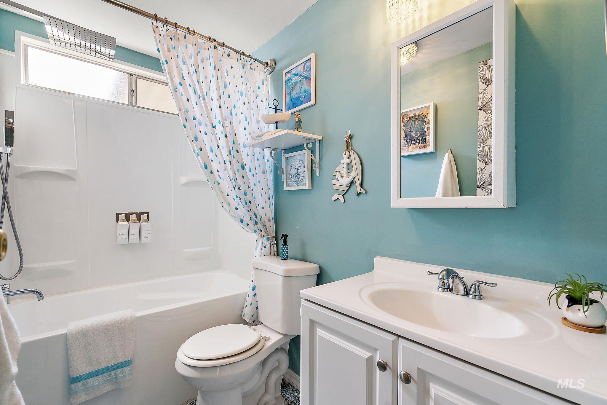 Bathroom with shower / bath combo and vanity