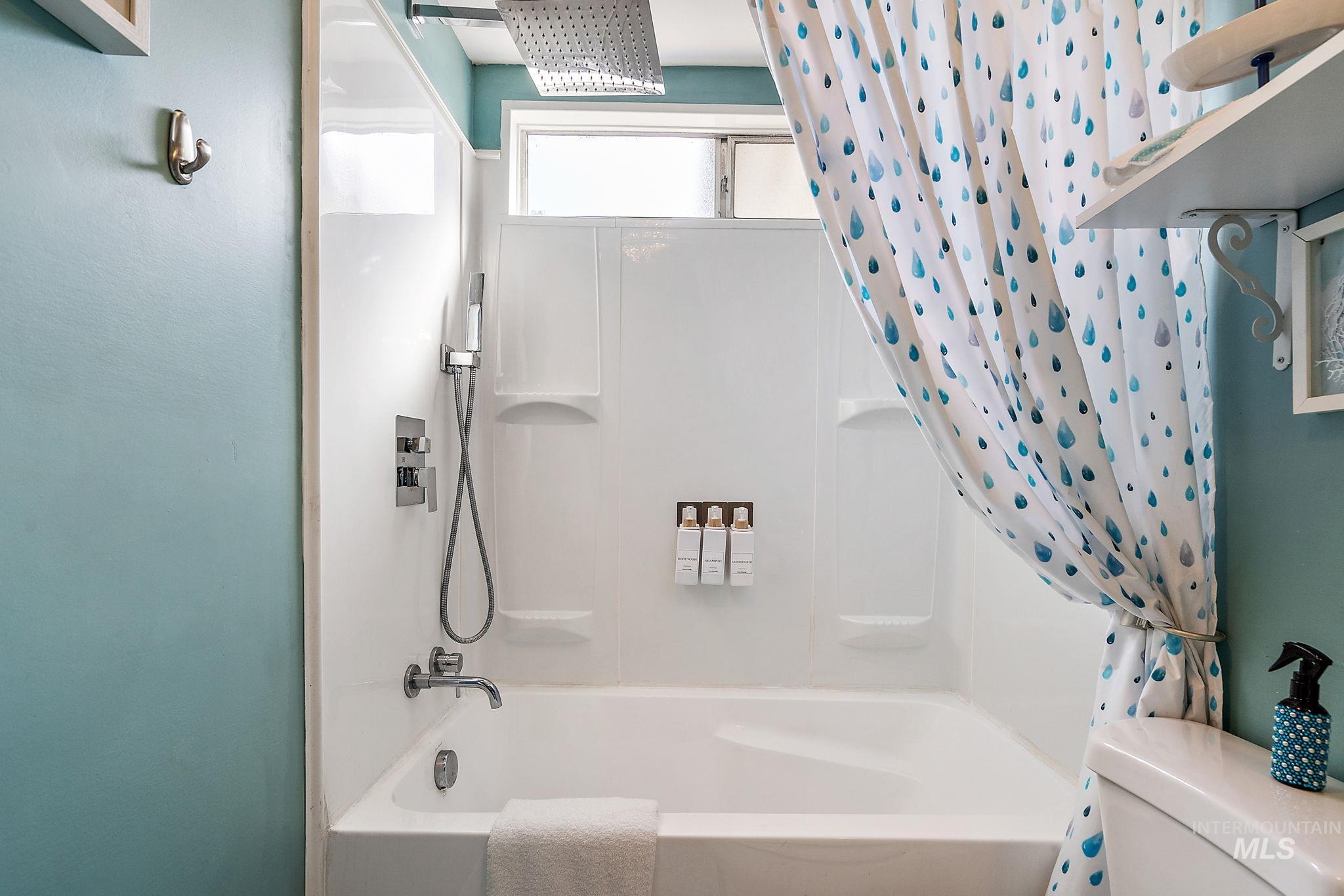 Bathroom featuring shower / bath combo and toilet
