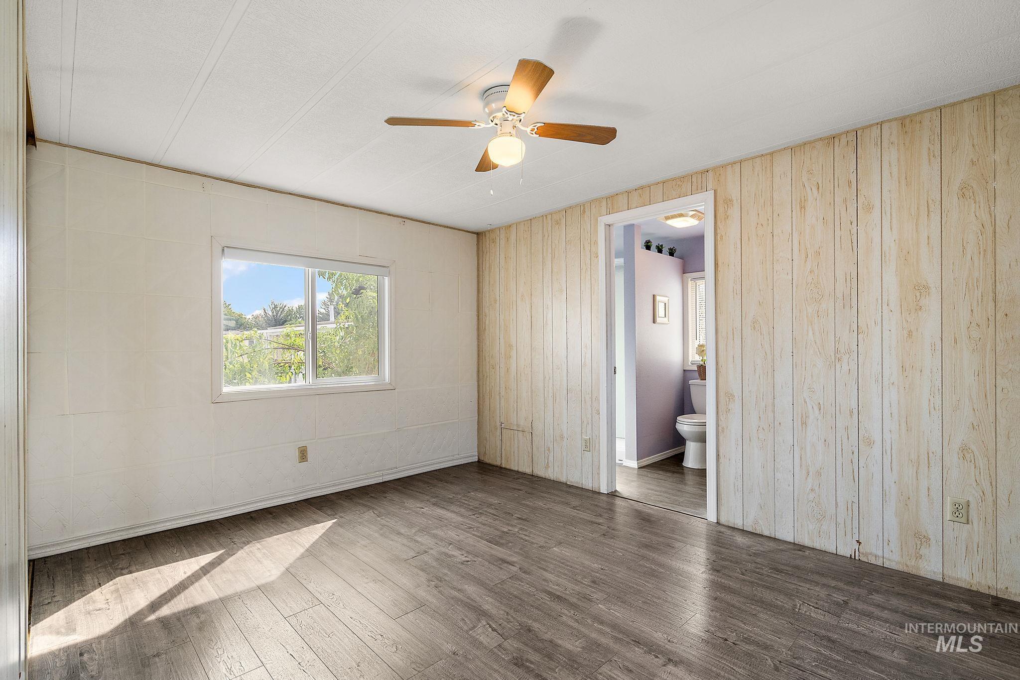 Master Bedroom with wood finished floors and ceiling fan
