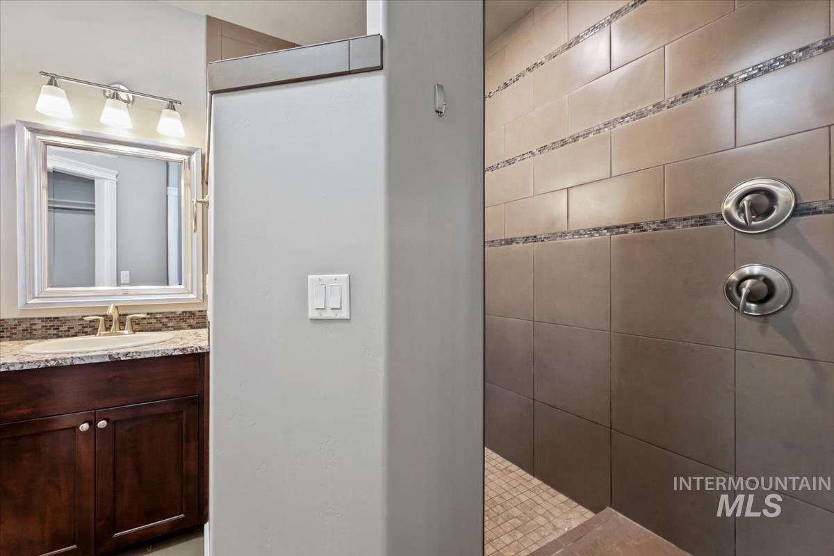 Full bathroom featuring walk in shower and vanity