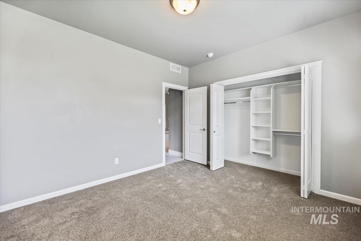 Unfurnished bedroom with carpet floors and a closet