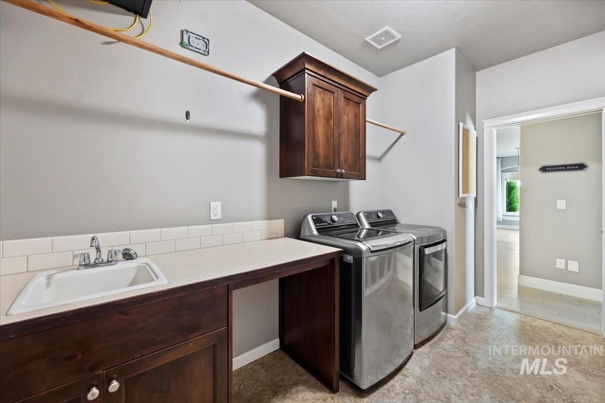Laundry area with cabinet space and washer and dryer