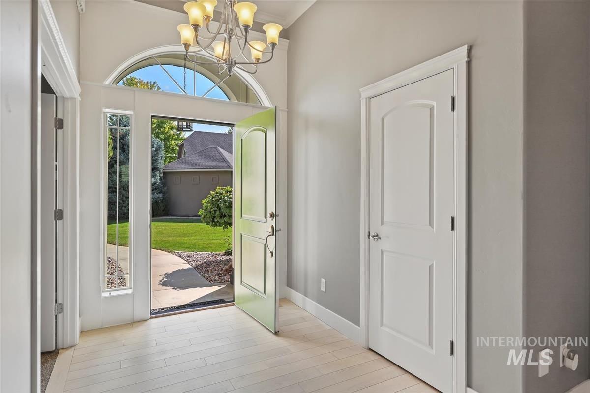 Foyer with a chandelier and light wood finished floors