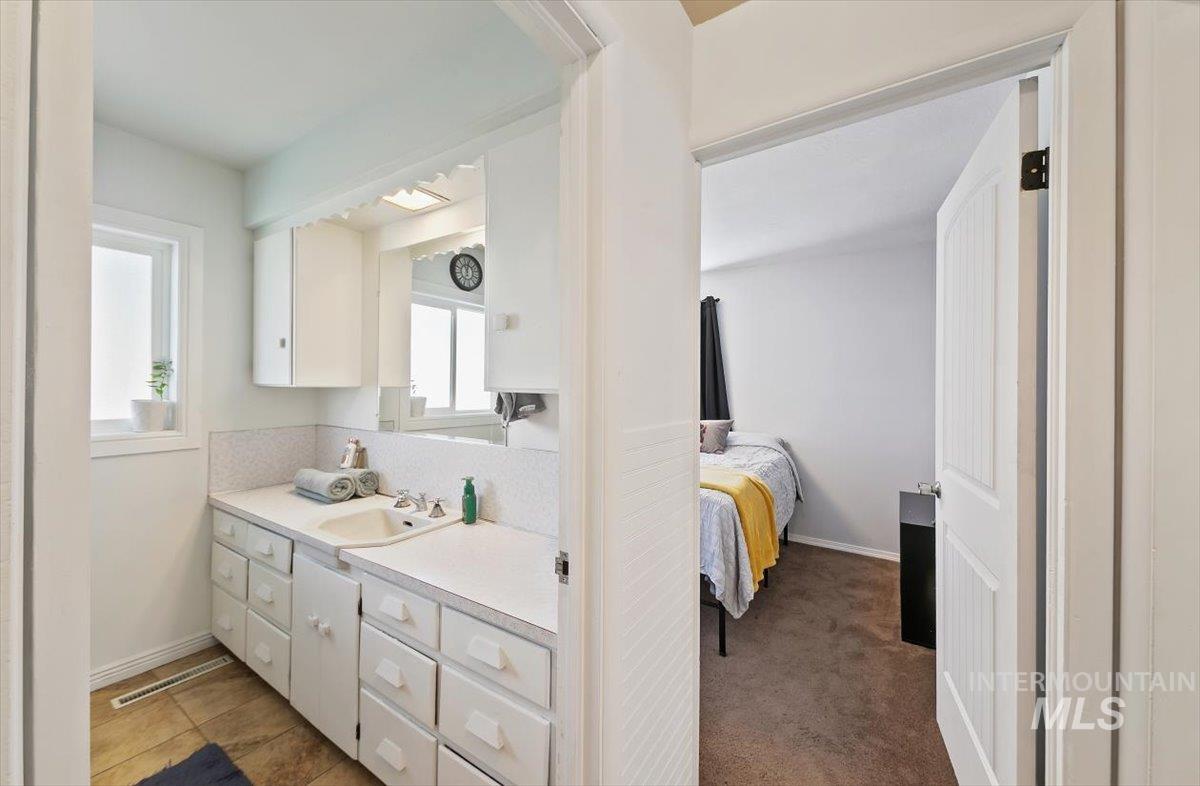 Bathroom with vanity and ensuite bathroom