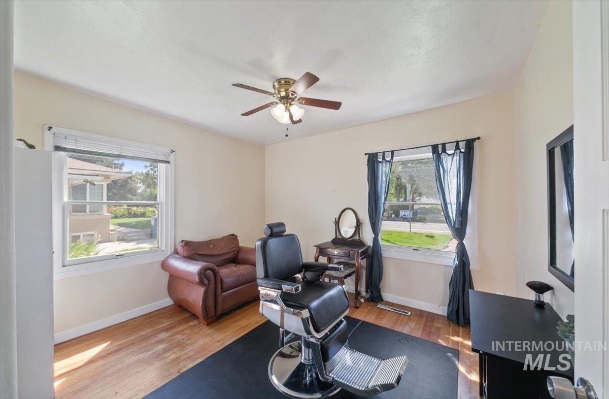 Workout area featuring wood finished floors and ceiling fan