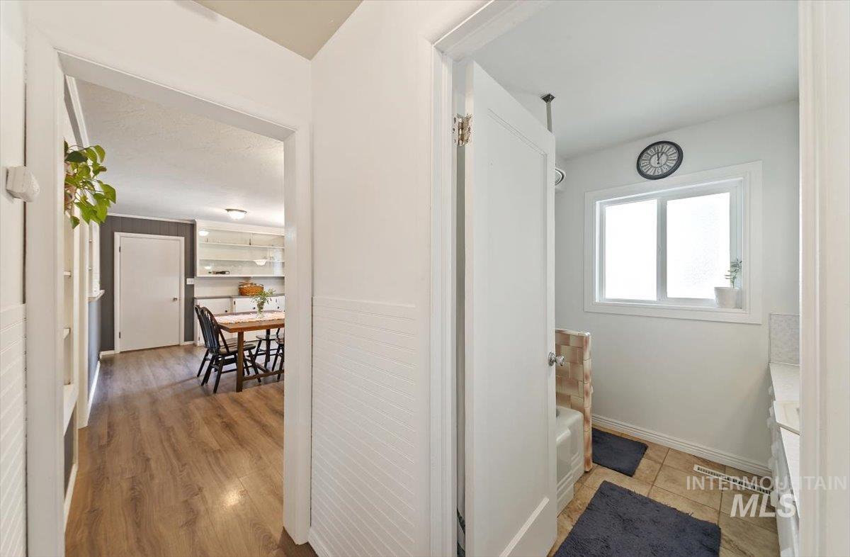 Corridor with baseboards and light wood-type flooring