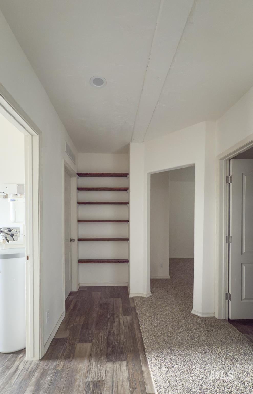 Hall with baseboards and dark wood finished floors