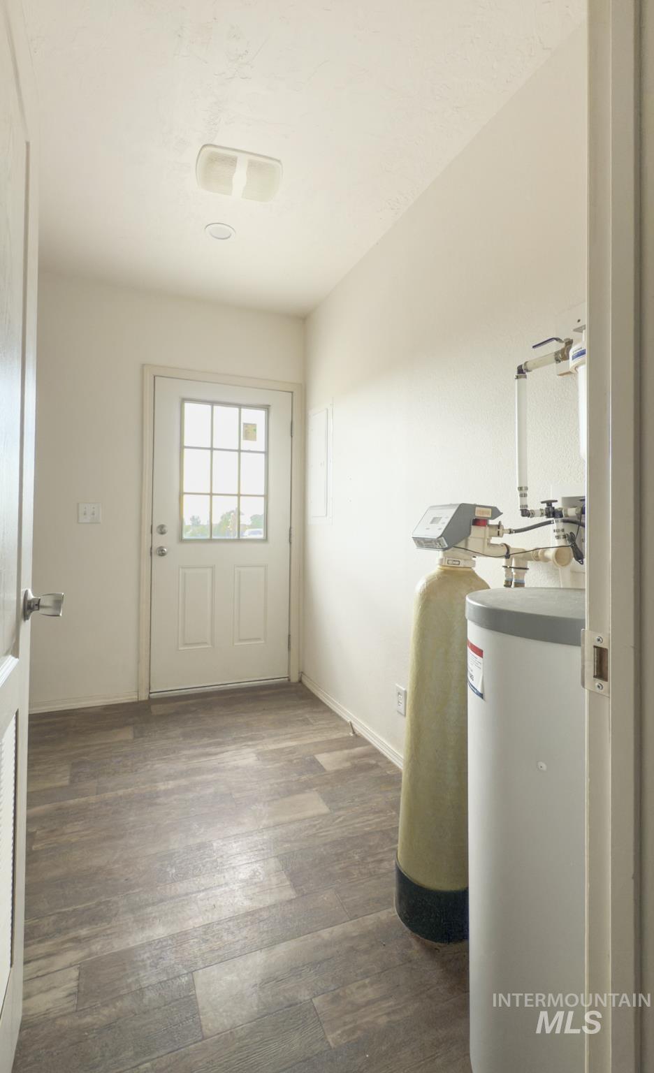 Washroom with dark wood finished floors and baseboards