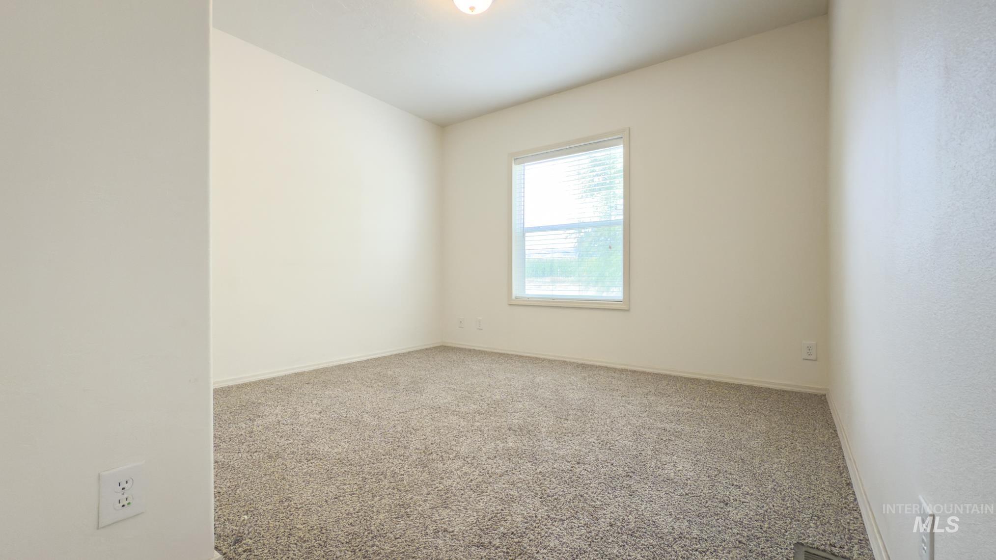 Unfurnished room with carpet flooring and baseboards