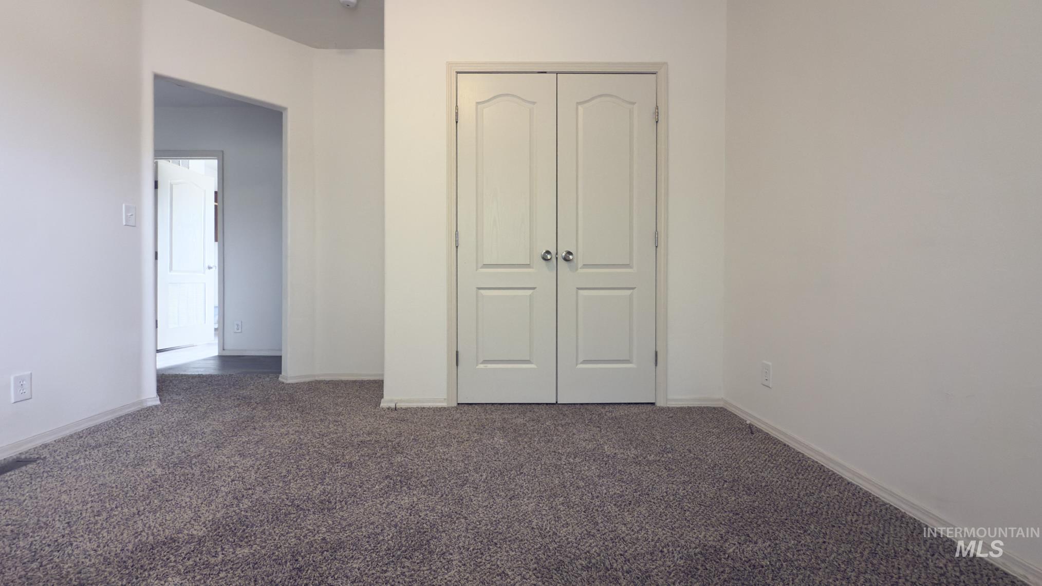 Unfurnished bedroom featuring carpet and a closet