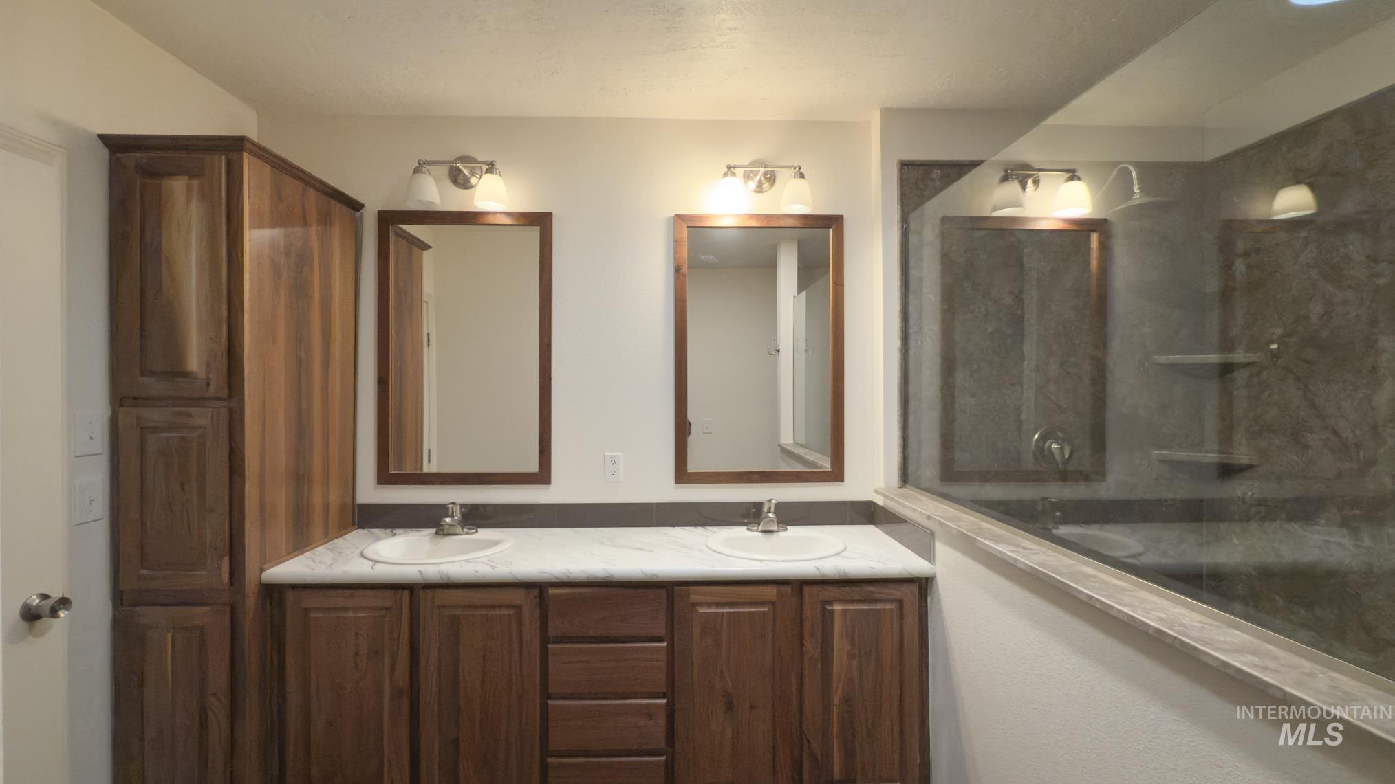 Full bath featuring double vanity