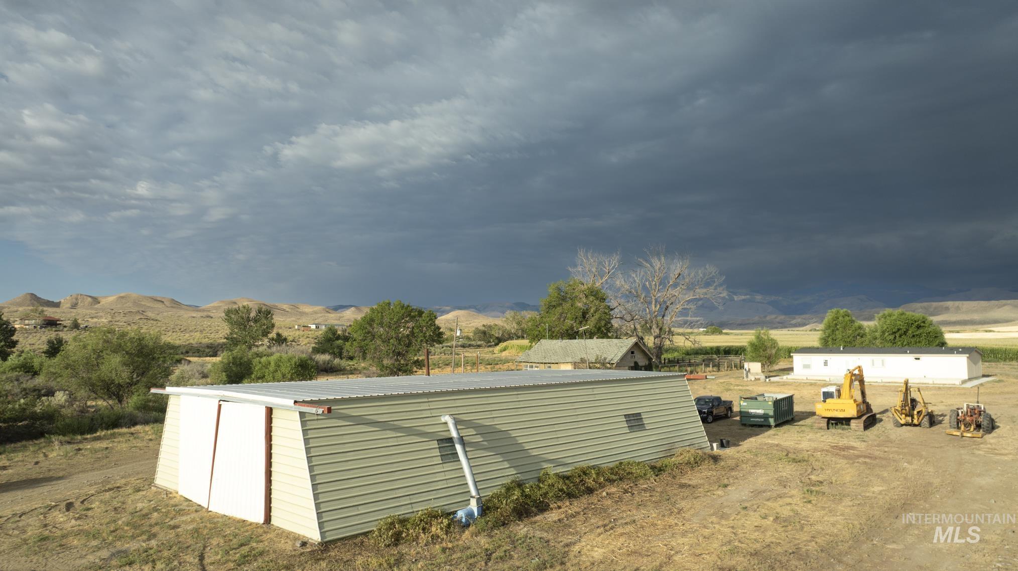 View of outdoor structure featuring a mountain view and a rural view