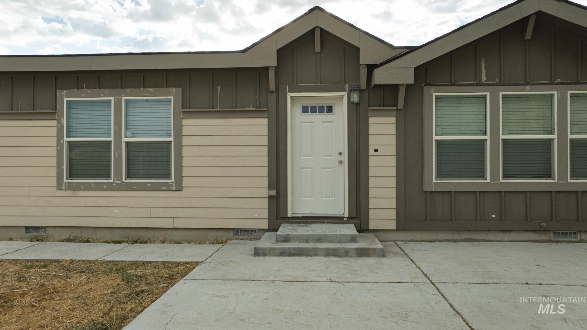 Entrance to property featuring crawl space and board and batten siding