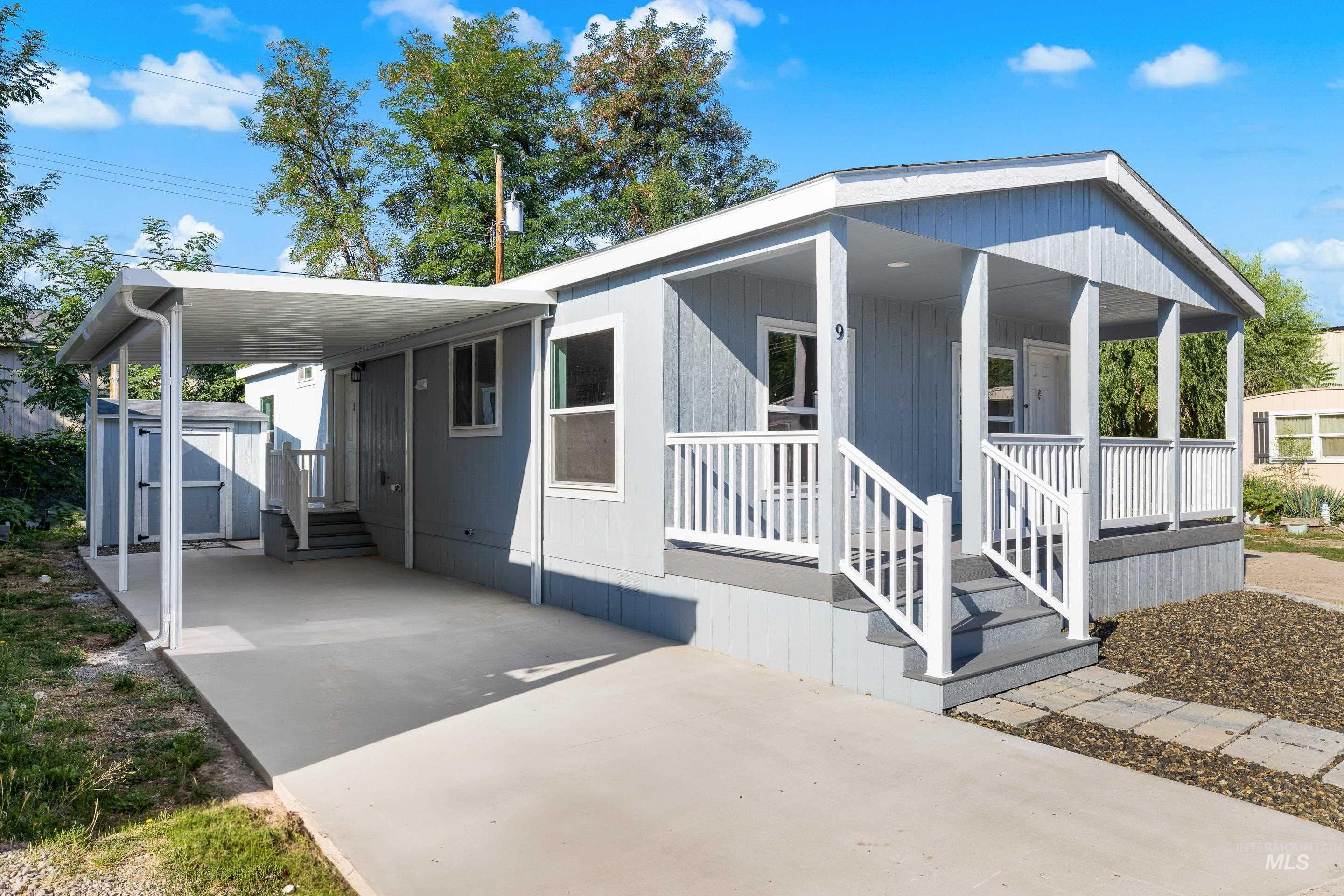 View of front of home featuring a shed, a porch, concrete driveway, and an attached carport