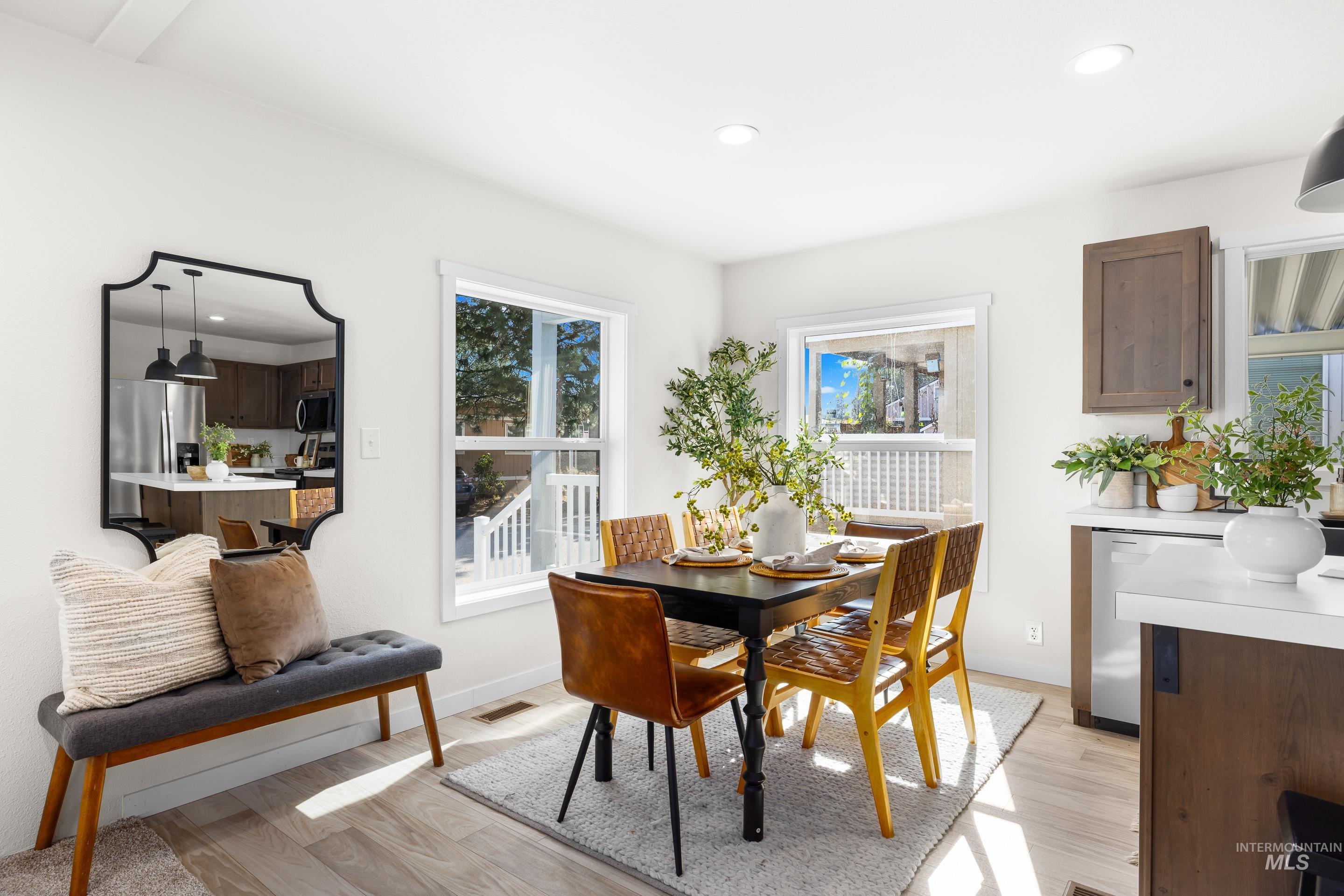 Dining space featuring recessed lighting, light wood-style floors, and plenty of natural light