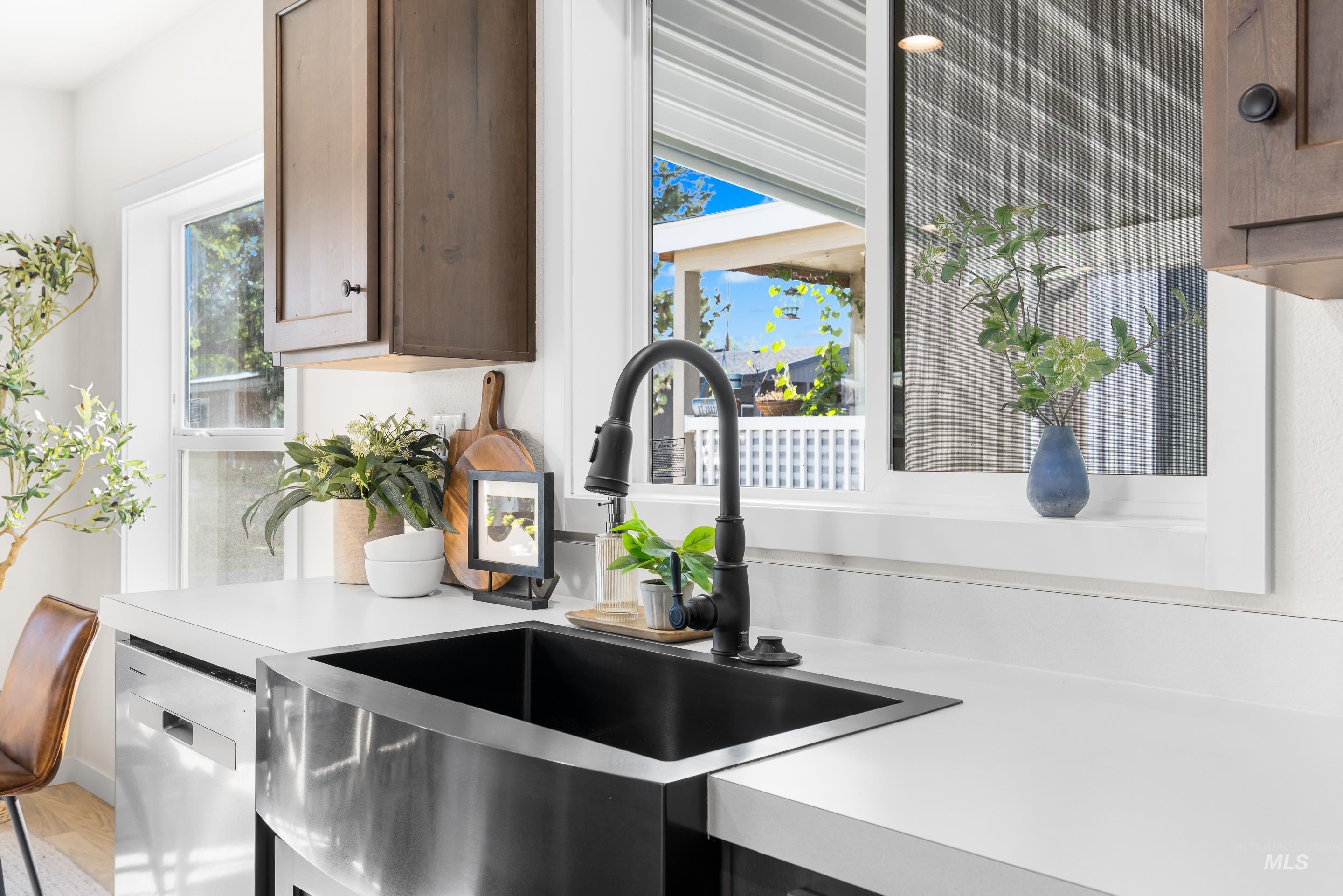 Kitchen with light countertops and dishwasher