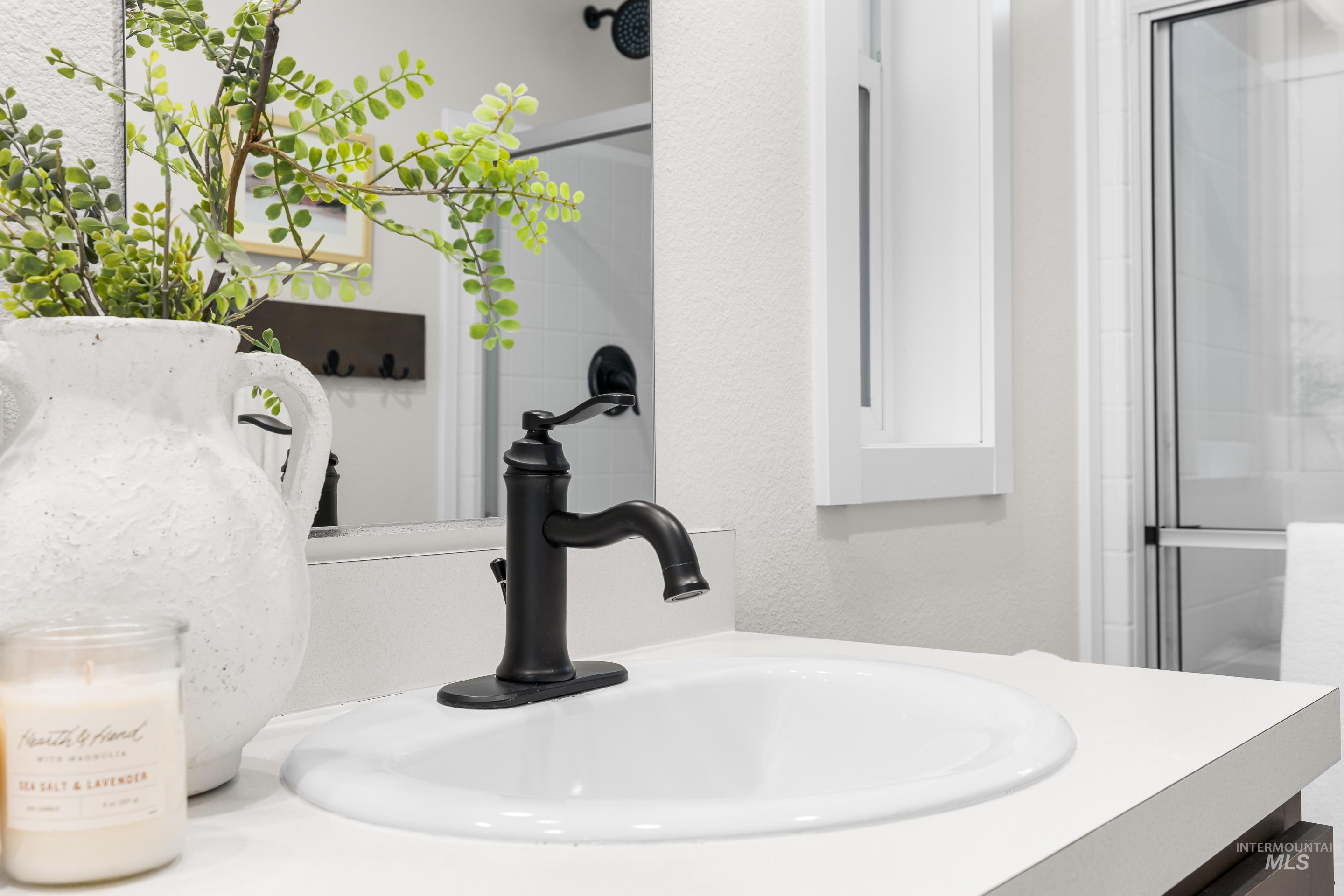 Bathroom view of vanity and an enclosed shower