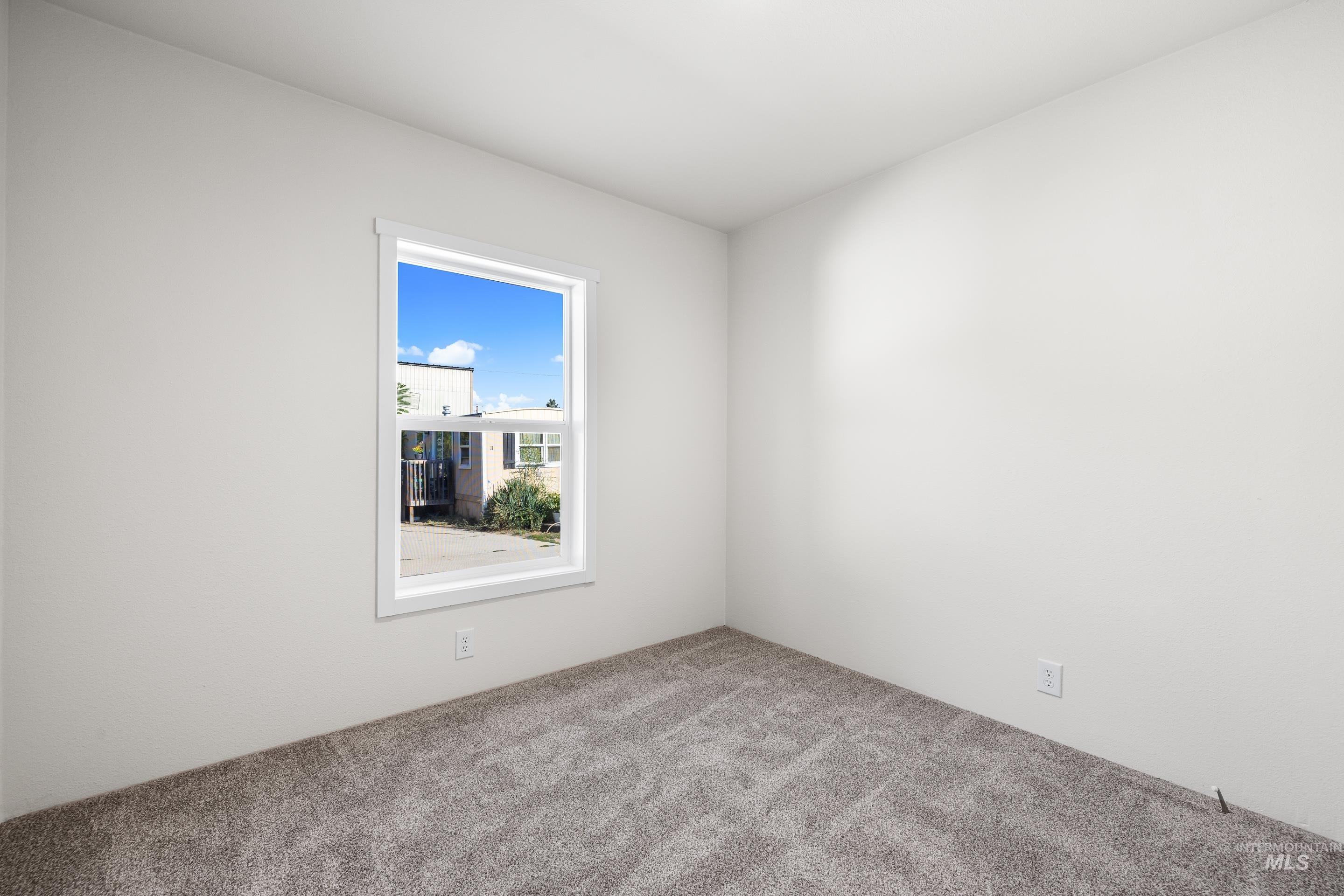 Spare room featuring carpet flooring