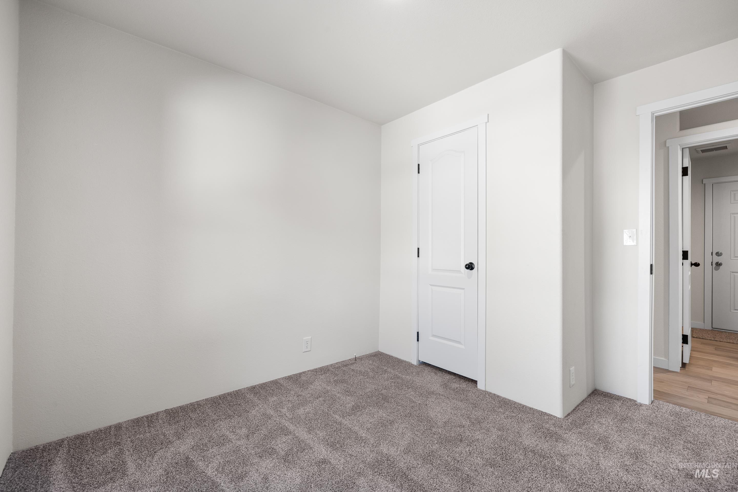 Unfurnished bedroom with carpet flooring