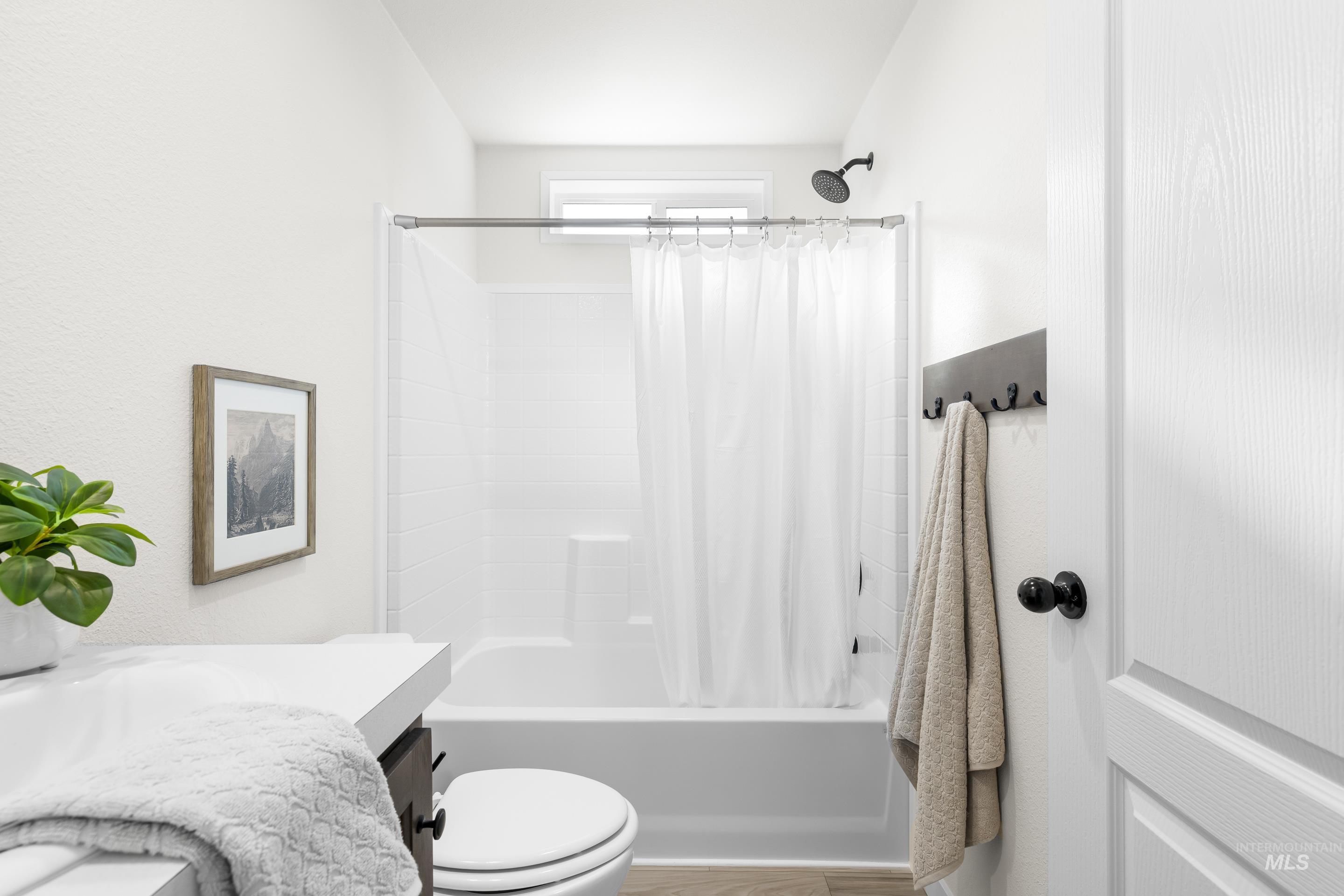 Full bathroom featuring shower / bathtub combination with curtain and vanity
