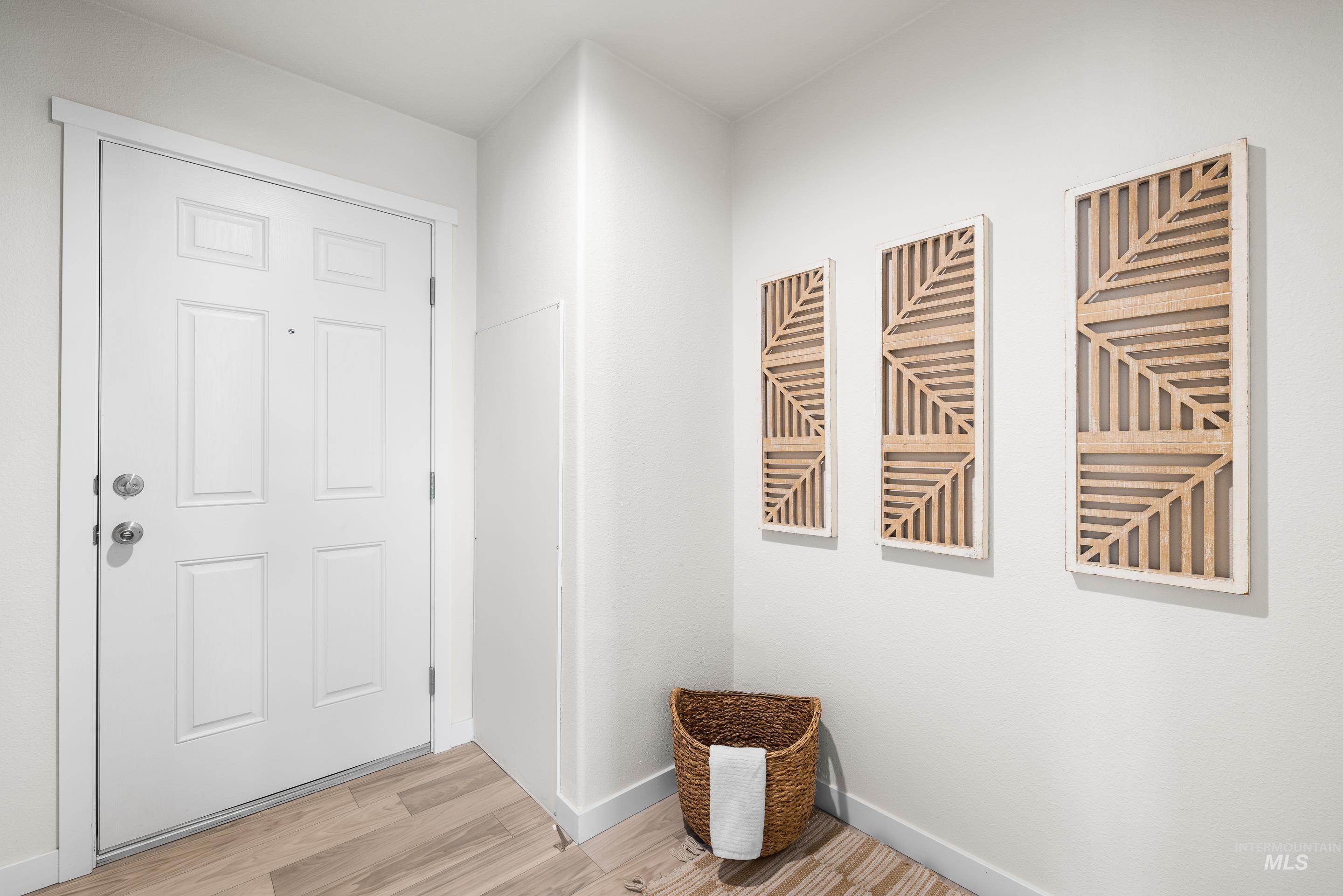 Entryway with wood finished floors and baseboards