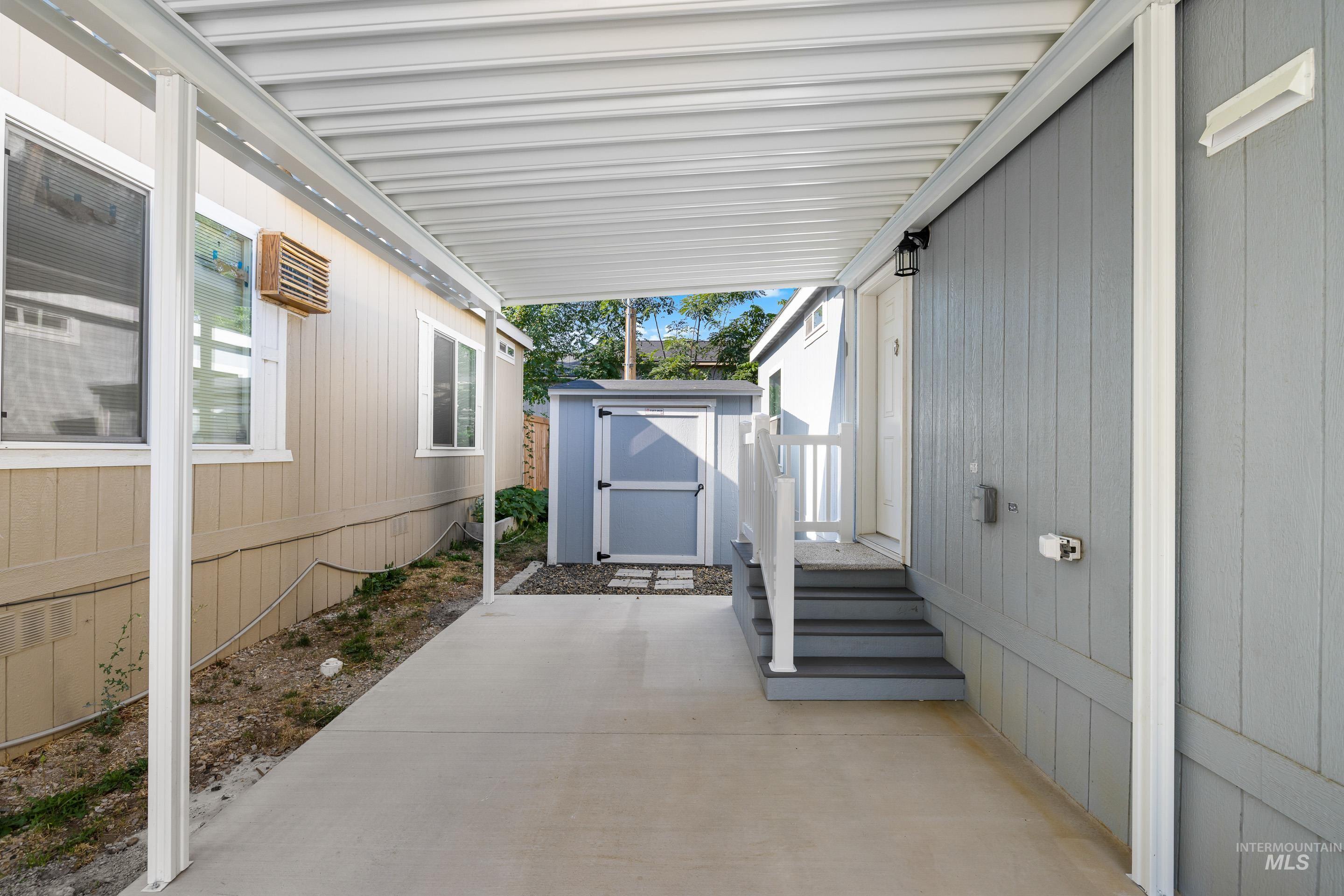 View of patio featuring a storage unit
