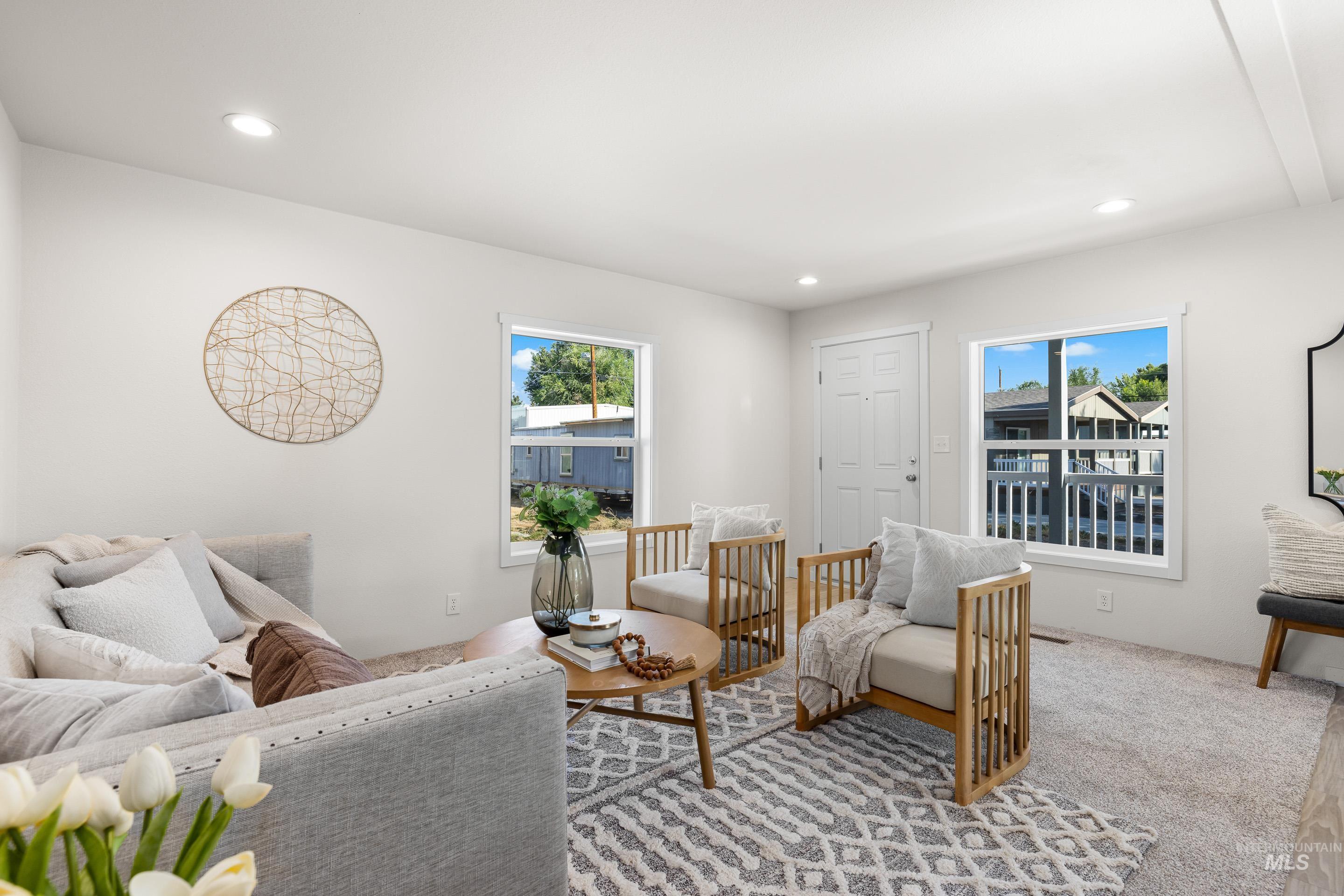 Carpeted living room with recessed lighting
