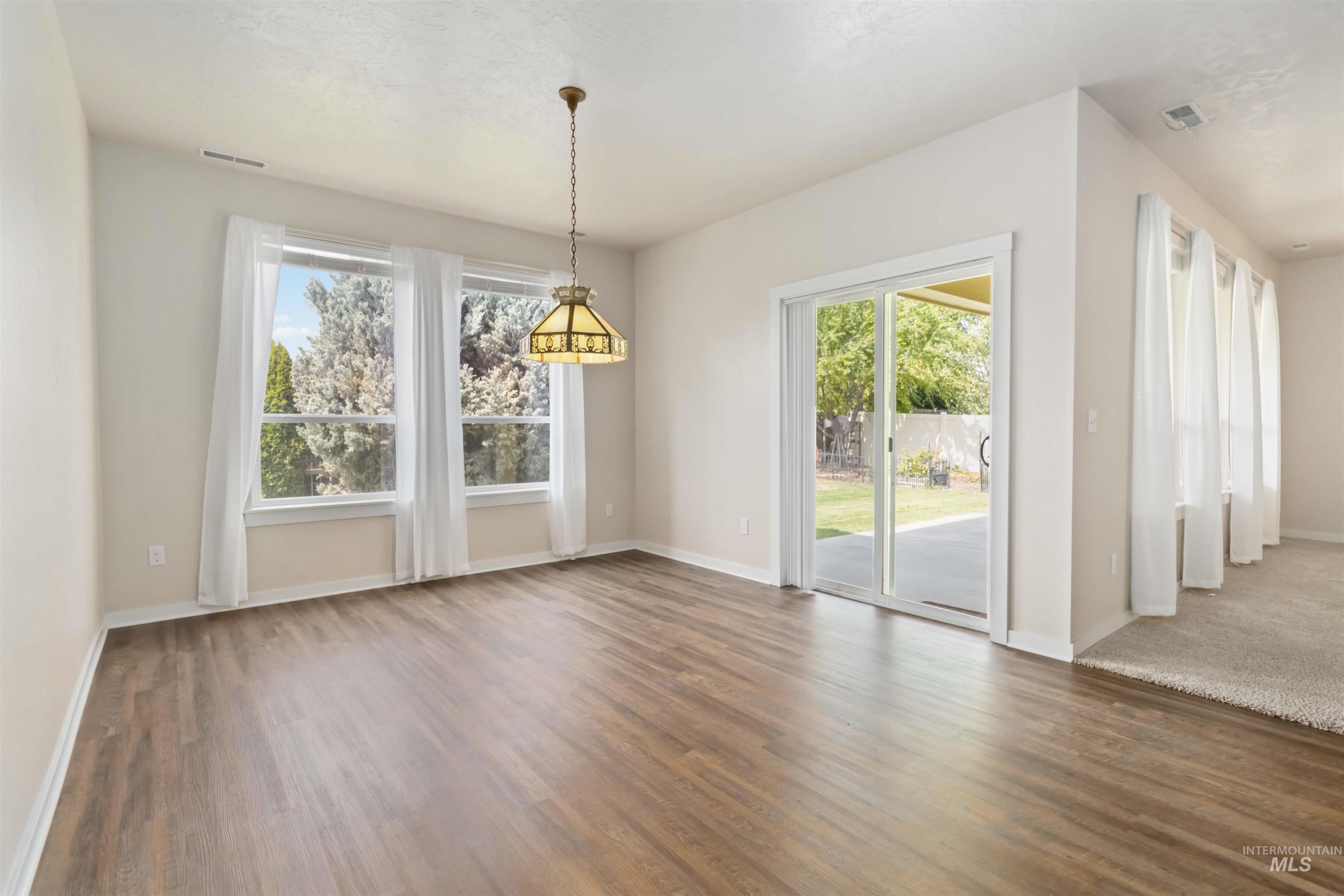 Unfurnished dining area featuring wood finished floors
